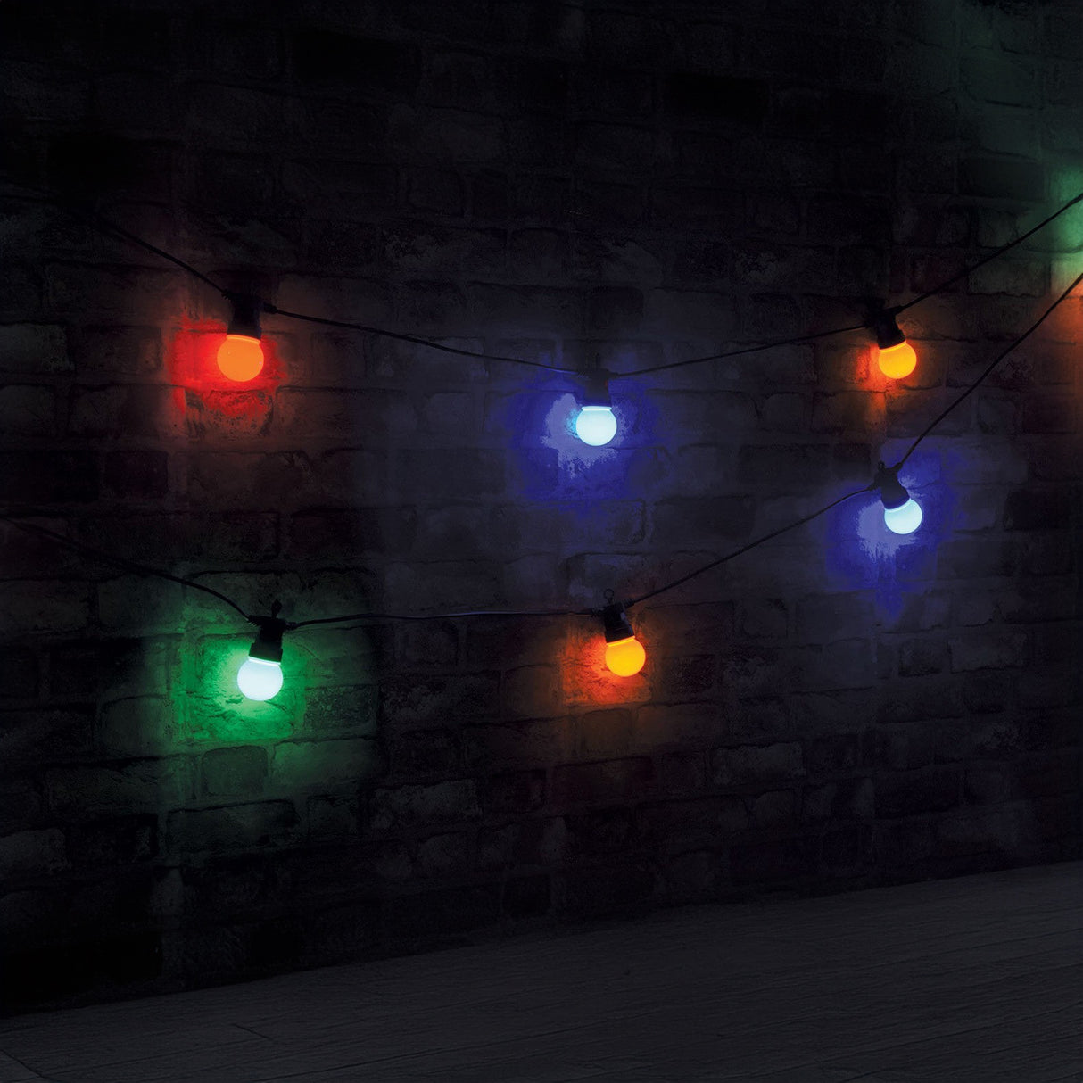 The LYYT Outdoor 10 Festoon Lights, featuring multicoloured bulbs, cast a gentle glow against the dark, textured brick wall, crafting a warm and festive atmosphere. These weatherproof LED lights are perfect for outdoor use, offering resilience against the elements while enhancing charm.