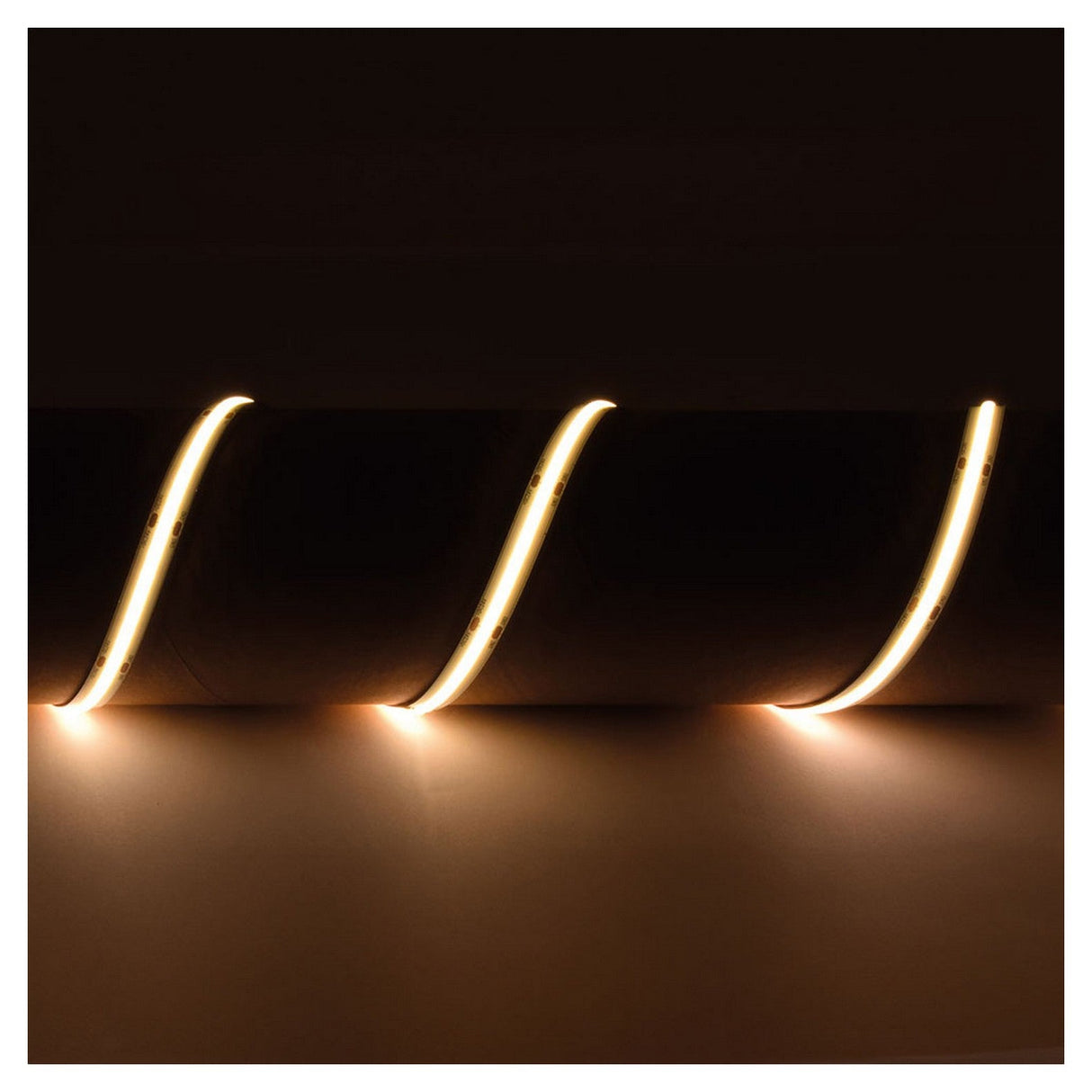 Close-up of glowing spiral LED neon light tubes against a dark background. The warm light, similar to that of the LYYT 24V COB LED Strip Light 5m - 3000K, creates an abstract pattern with gentle curves and reflections on the surface below.