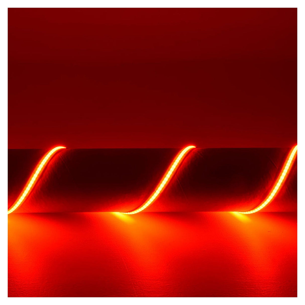 A vibrant red neon effect is created by the LYYT 24V COB LED Strip Light 5m - RGB, forming wavy lines against a dark red background and casting a warm glow on the surface. This continuous linear lighting effect is enhanced by its flexible COB strip, bringing an immersive ambiance to life.