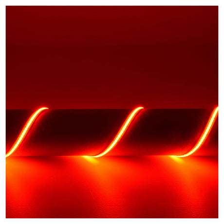 A vibrant red neon effect is created by the LYYT 24V COB LED Strip Light 5m - RGB, forming wavy lines against a dark red background and casting a warm glow on the surface. This continuous linear lighting effect is enhanced by its flexible COB strip, bringing an immersive ambiance to life.