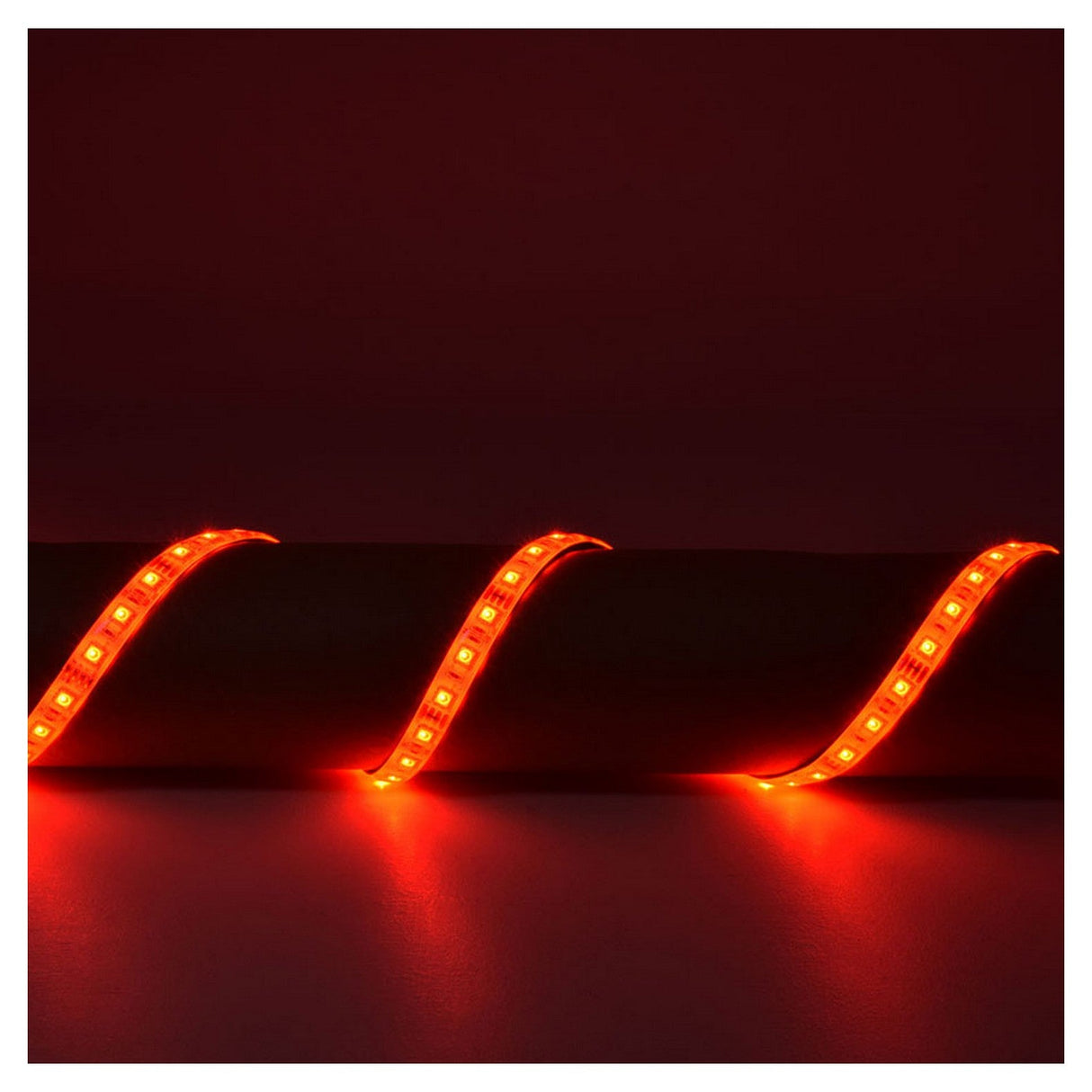 The LYYT 12V RGB LED Strip Light 5m - 60 LED/m emits a glowing red hue that forms gentle waves on a dark surface, producing a warm and vibrant illumination against the shadowy background. Rated IP65 for durability, this LED strip ensures low power consumption while delivering efficient and stunning lighting effects.