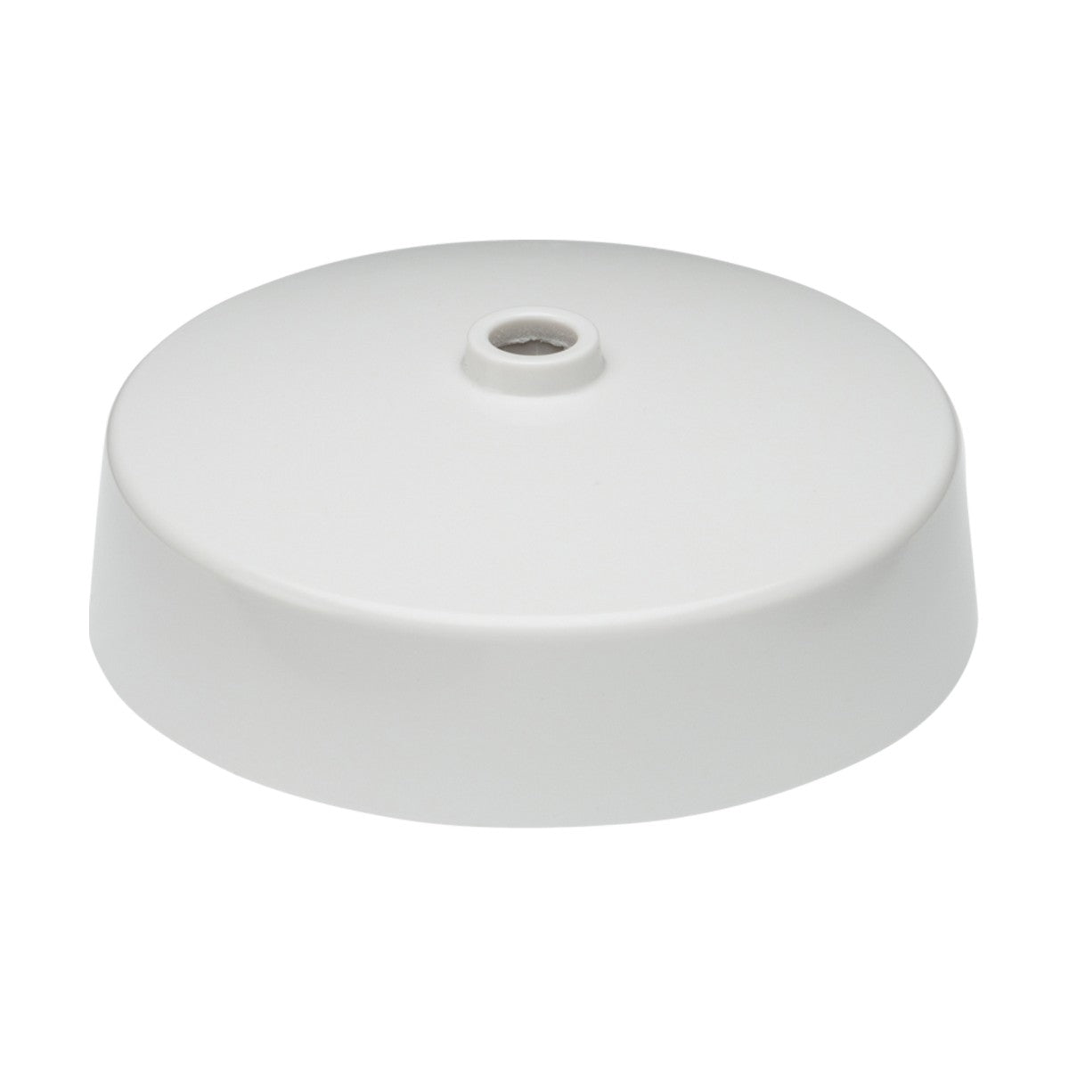 The Light Fitting Ceiling Rose, a plain white ceiling canopy, includes a central hole for wiring and is crafted for attaching light fixtures or ceiling fans. It features a smooth, circular design with a slightly elevated edge.