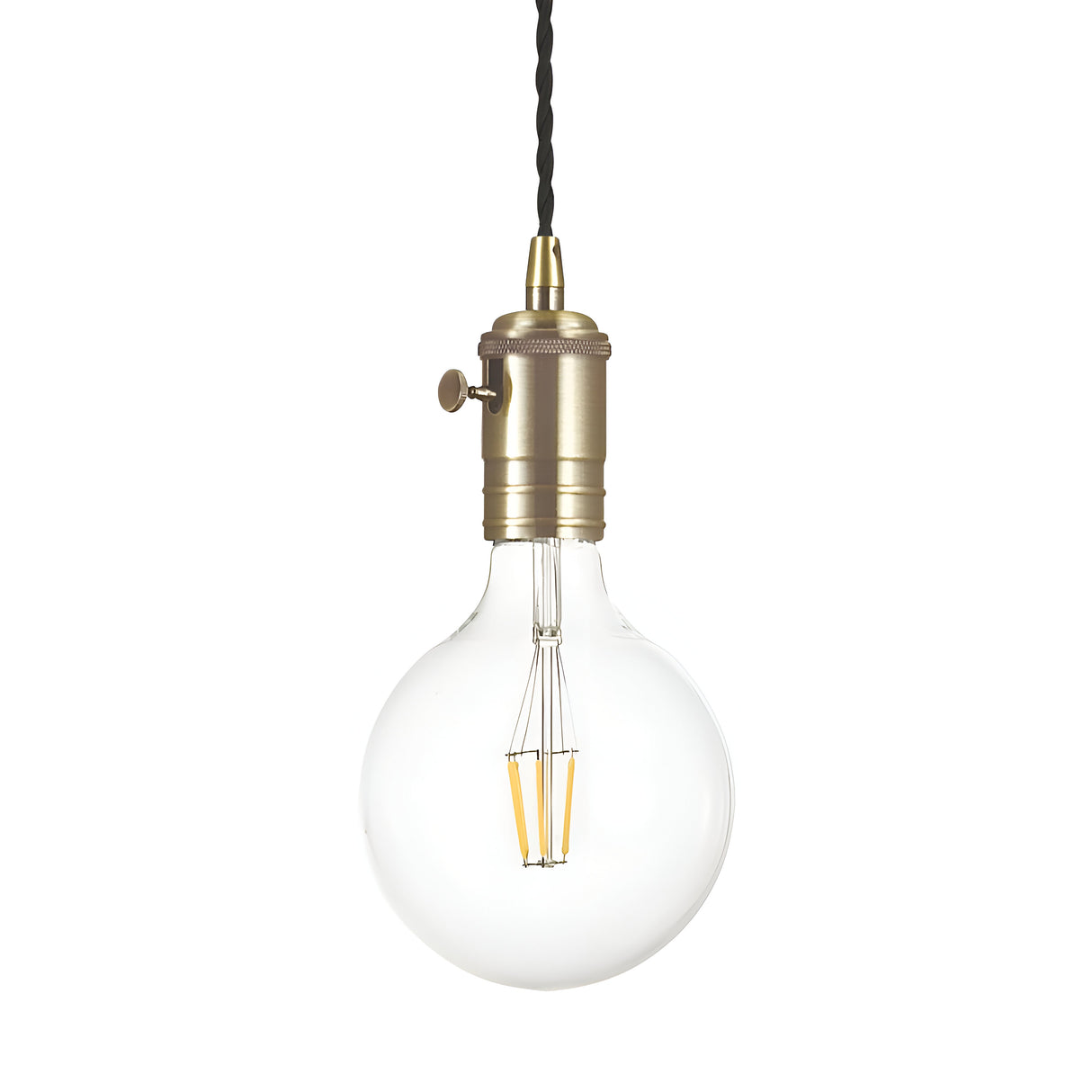 The Lantern 1 Light Pendant - Antique Brass features a vintage-style design with a visible filament and hangs from a twisted black cord. Its clear, round bulb complements the antique brass fixture, which includes a simple switch on the side. The white background accentuates its timeless elegance.