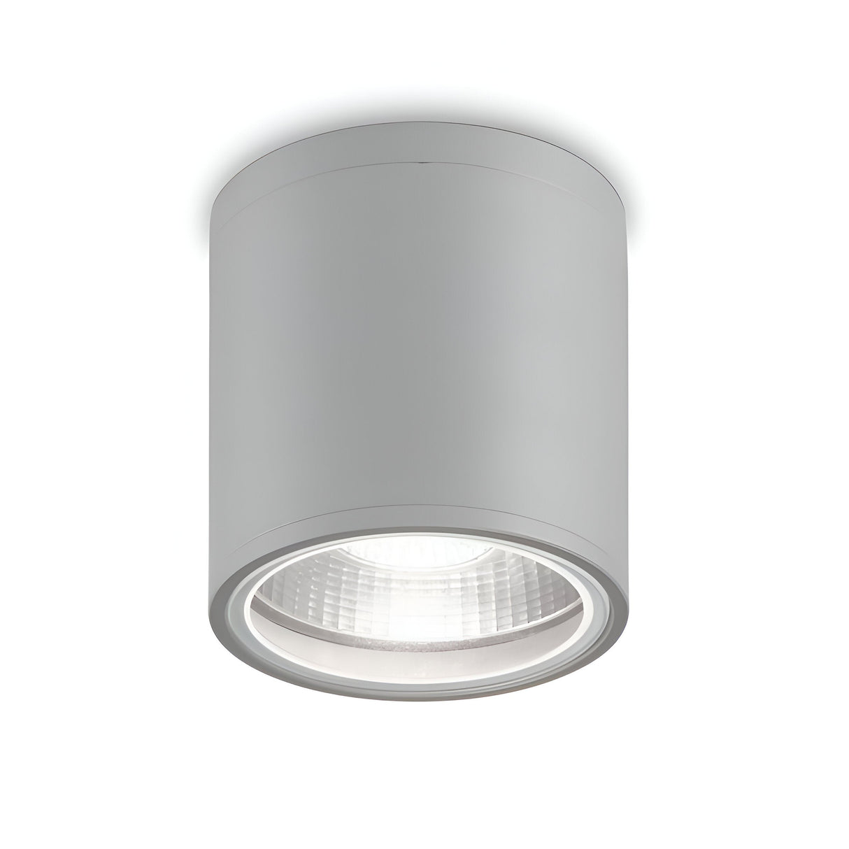 Introducing the Solar Downlight - Grey: a contemporary, cylindrical ceiling light fixture with an aluminum body and a sleek silver finish, flush-mounted against a white ceiling. This minimalist design highlights clean lines and exudes elegance, while its IP44 rating ensures enhanced durability.