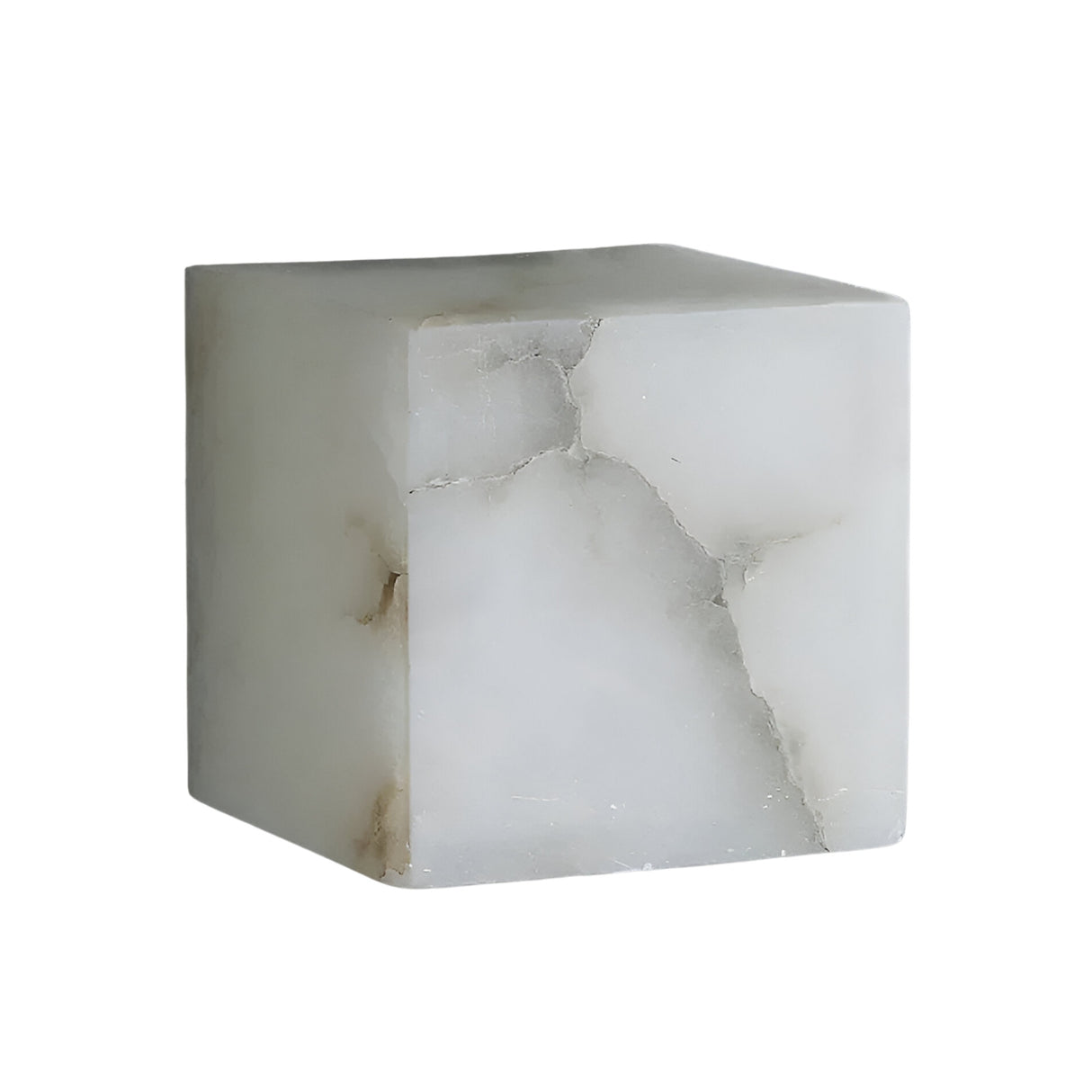 The Calmora 1 Light Block Alabaster Wall Light in Soft White features a translucent cube of Spanish alabaster with natural gray and beige veining, displayed on a plain white background.