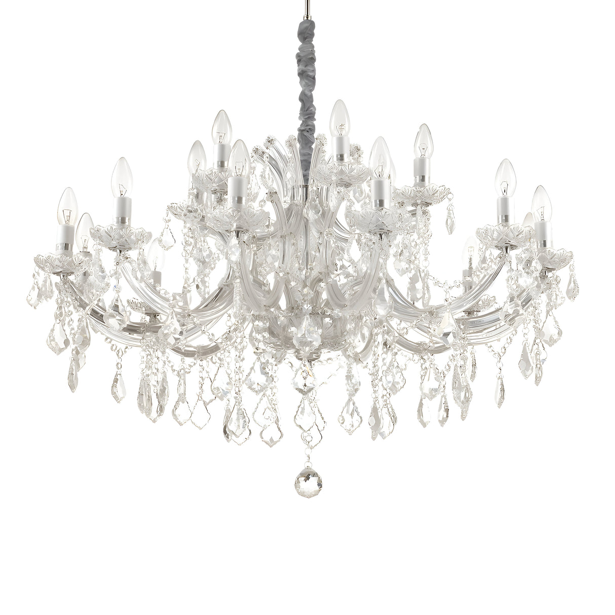 The Grove Crystal 18 Light Chandelier - Chrome is a stunning piece with multiple arms that feature candle-style bulbs and hanging crystal ornaments, elegantly suspended from the ceiling. The chrome finish enhances light refraction through the crystals, creating a dazzling sparkle throughout the room.