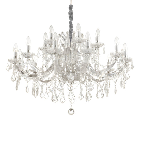 The Grove Crystal 18 Light Chandelier - Chrome is a stunning piece with multiple arms that feature candle-style bulbs and hanging crystal ornaments, elegantly suspended from the ceiling. The chrome finish enhances light refraction through the crystals, creating a dazzling sparkle throughout the room.