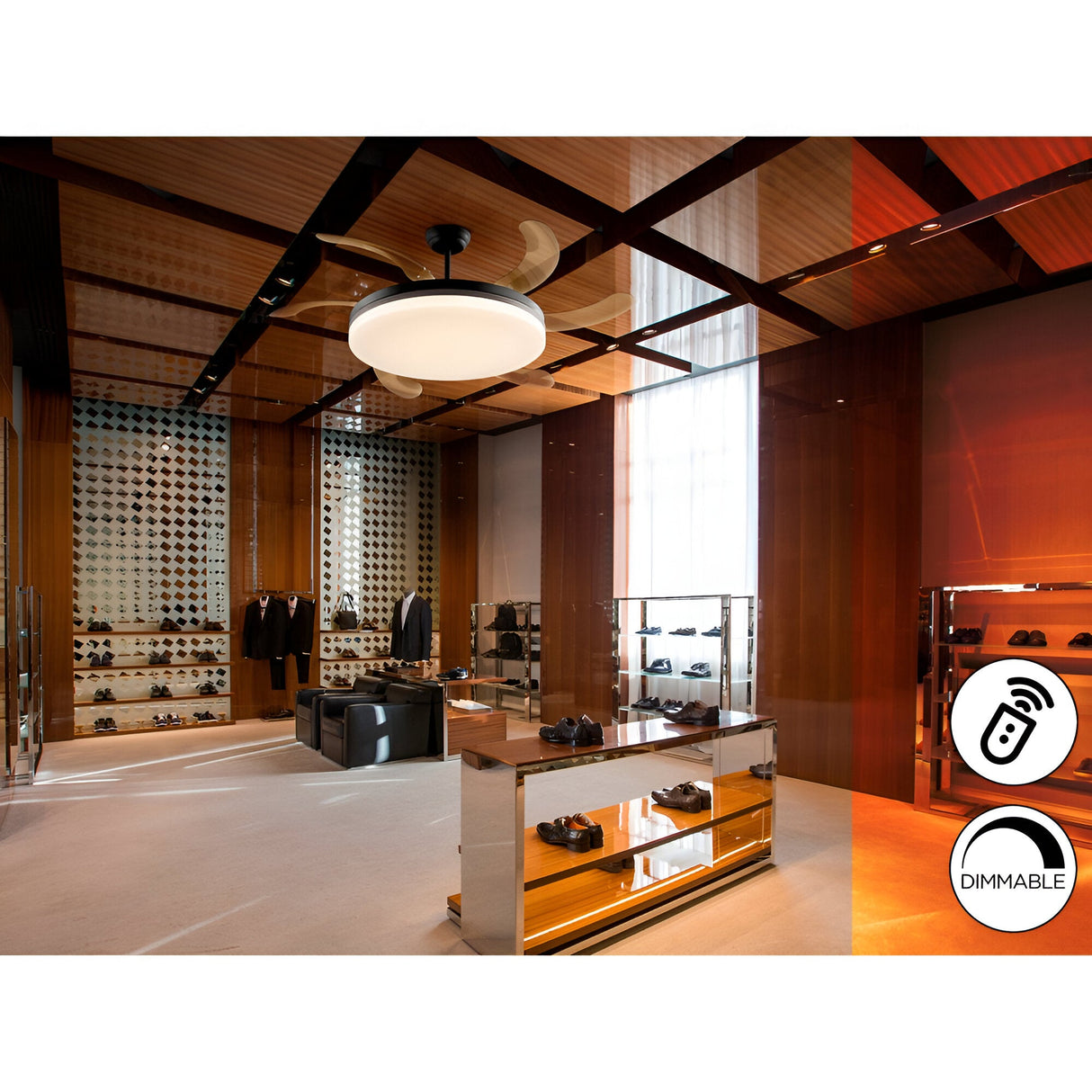 Schuller Vento Maxi LED ceiling fan light with retractable blades and opal diffuser in matt black and bronze, installed in a wood-panelled retail interior.