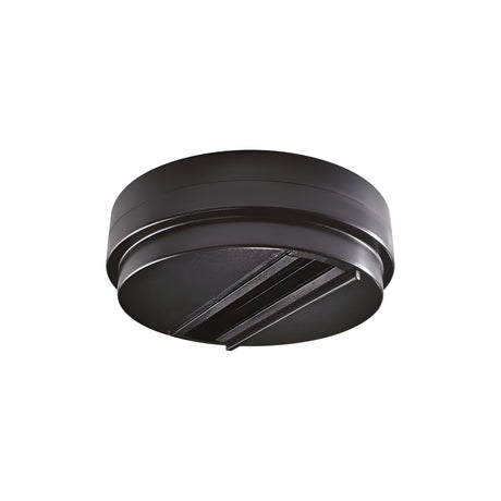 Introducing the Brillia Ceiling-Mounted Track Lighting Adapter in black, crafted from durable plastic with a circular design. It is perfect for contemporary lighting setups, including track lighting adapters or smoke detectors. The adapter showcases a sleek exterior with a subtly elevated center and two elongated openings, making it ideal for ceiling-mounted devices.