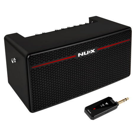 A black NU-X Mighty Space Portable Wireless Modelling Amplifier, designed with a grid-like speaker cover and control knobs on top, boasts Bluetooth connectivity. In front of the amplifier sits a small black wireless transmitter with a plug, poised to provide seamless audio performance.