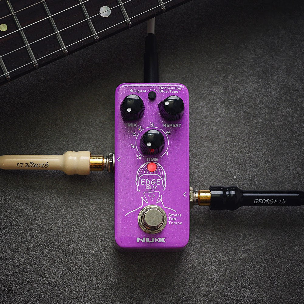 NU-X NDD-3 Edge Mini Delay Pedal in purple with Mix, Repeat and Time knobs, red mode button and footswitch, shown with guitar neck and jack leads.