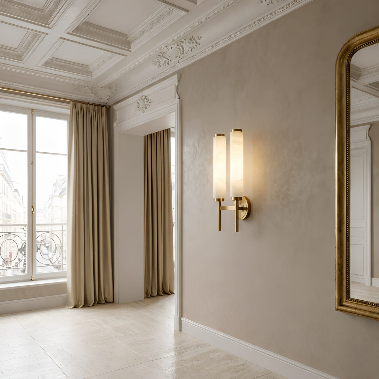Elegant room with tall windows, beige curtains, wall molding, and a gold-framed mirror. The Noctera LED Twin Column Alabaster Wall Light in Soft White & Brushed Brass casts a warm glow on the neutral walls.