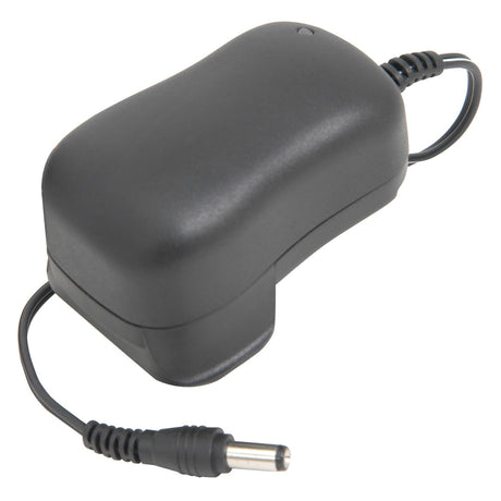 The Chord Guitar Pedal PSU - UK Plug is a black power adaptor featuring a curved, rectangular body and a cable that ends in a cylindrical plug. Ideal for guitar effects, its coiled cable is designed with energy efficiency in mind.