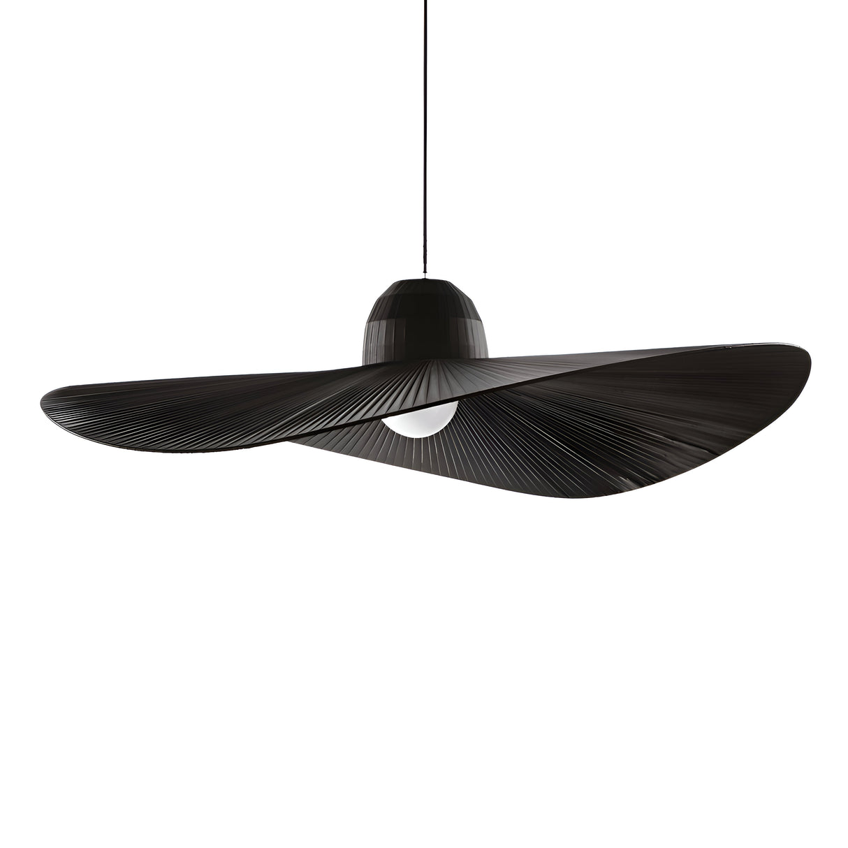The Eclipso 1 Light Pendant in Black is a dimmable fixture that boasts a unique, flowing sculptural design. Its smooth, curving shape evokes the appearance of a fan or wing, with the central lightbulb visibly located at the bottom. Suspended from a thin cable, this pendant light adds elegance to any setting.