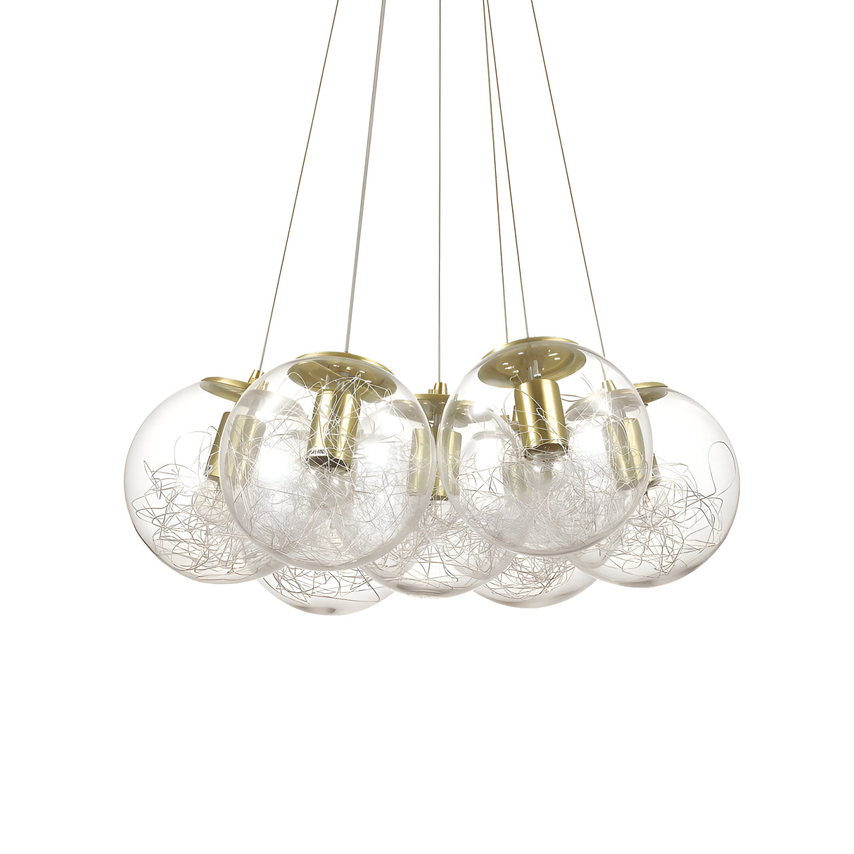The Lyria 7 Light Cluster Pendant - Brass features a contemporary style with its seven glass spheres. Inside each sphere is a nest of silver wires, all elegantly suspended by delicate wires and highlighted by a brass finish, bringing sophistication to any room.