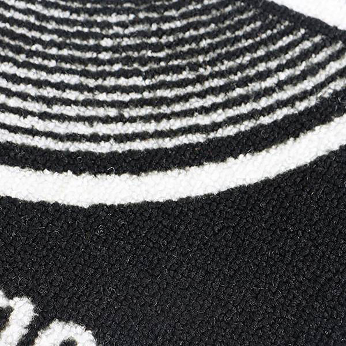 Close-up of the NU-X Heavy Duty Drum Rug by AVSL showing the black textured pile with white concentric ring detailing.