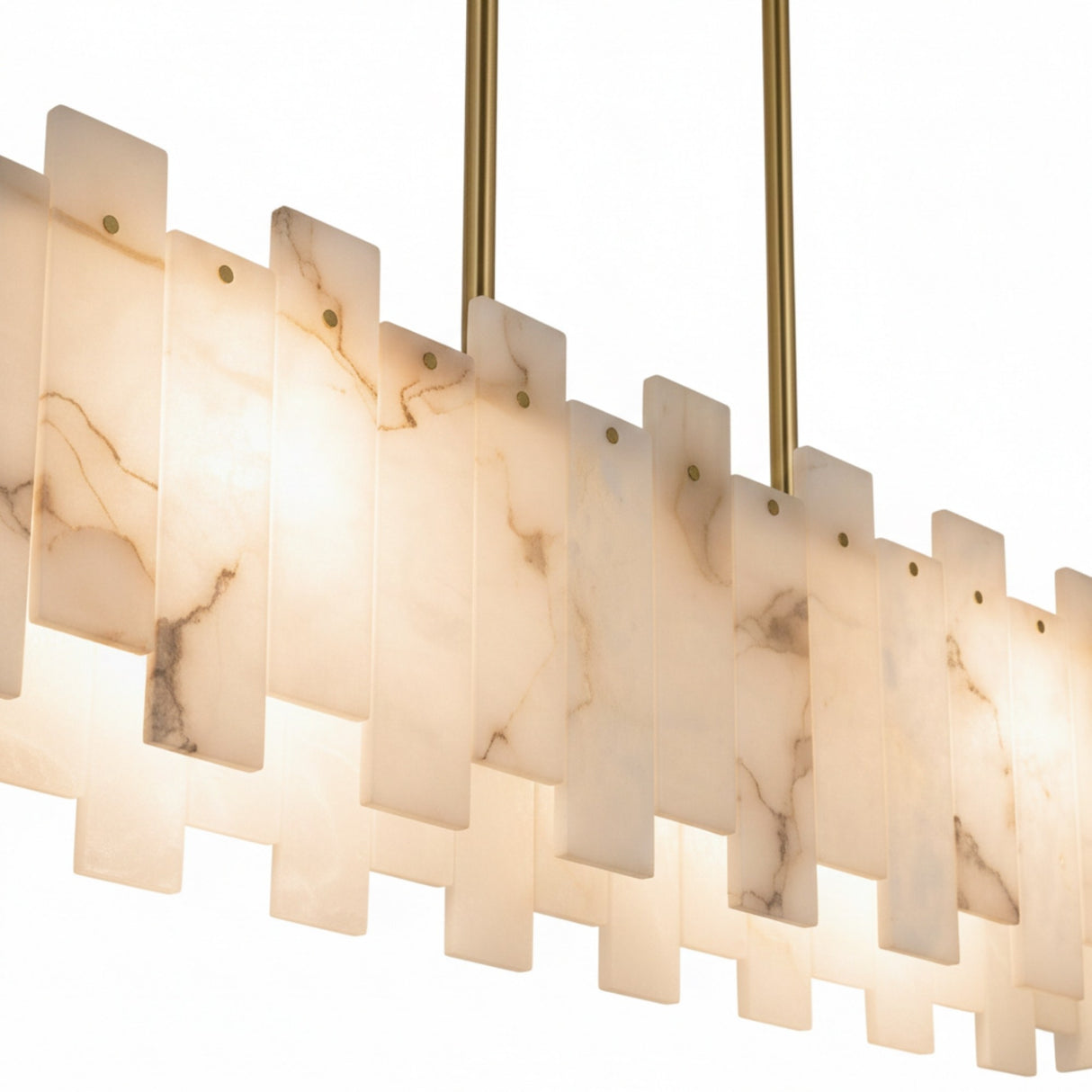 The Zarelli 8 Light Interlocking Panel Alabaster Linear Chandelier in Soft White & Brass features overlapping rectangular alabaster panels and slender brass rods, offering a warm, translucent glow against a plain white background.