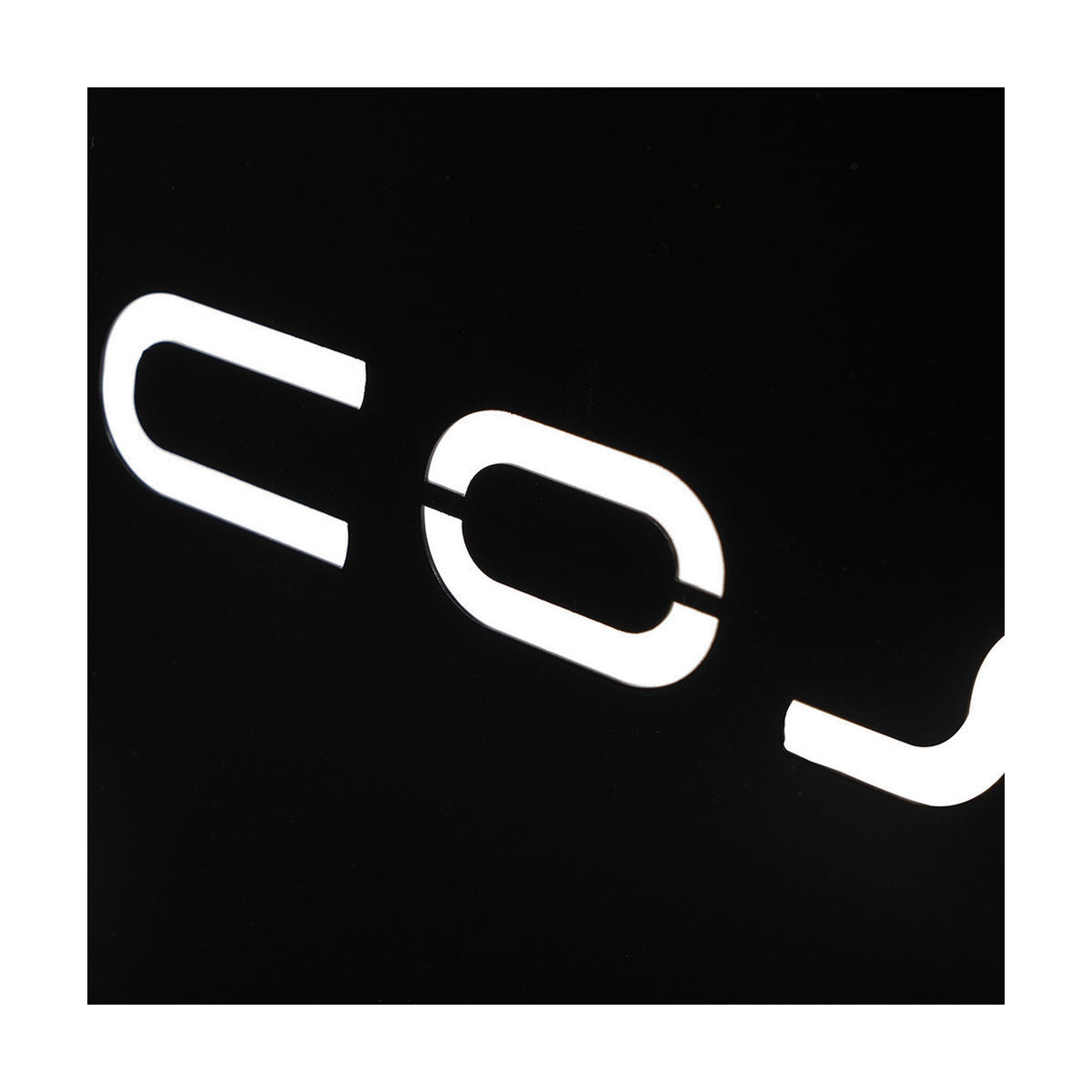 Close-up of the Cosi Cover Plate for Large Glass Set, 52cm, showing white lettering on a black surface against a plain dark background.