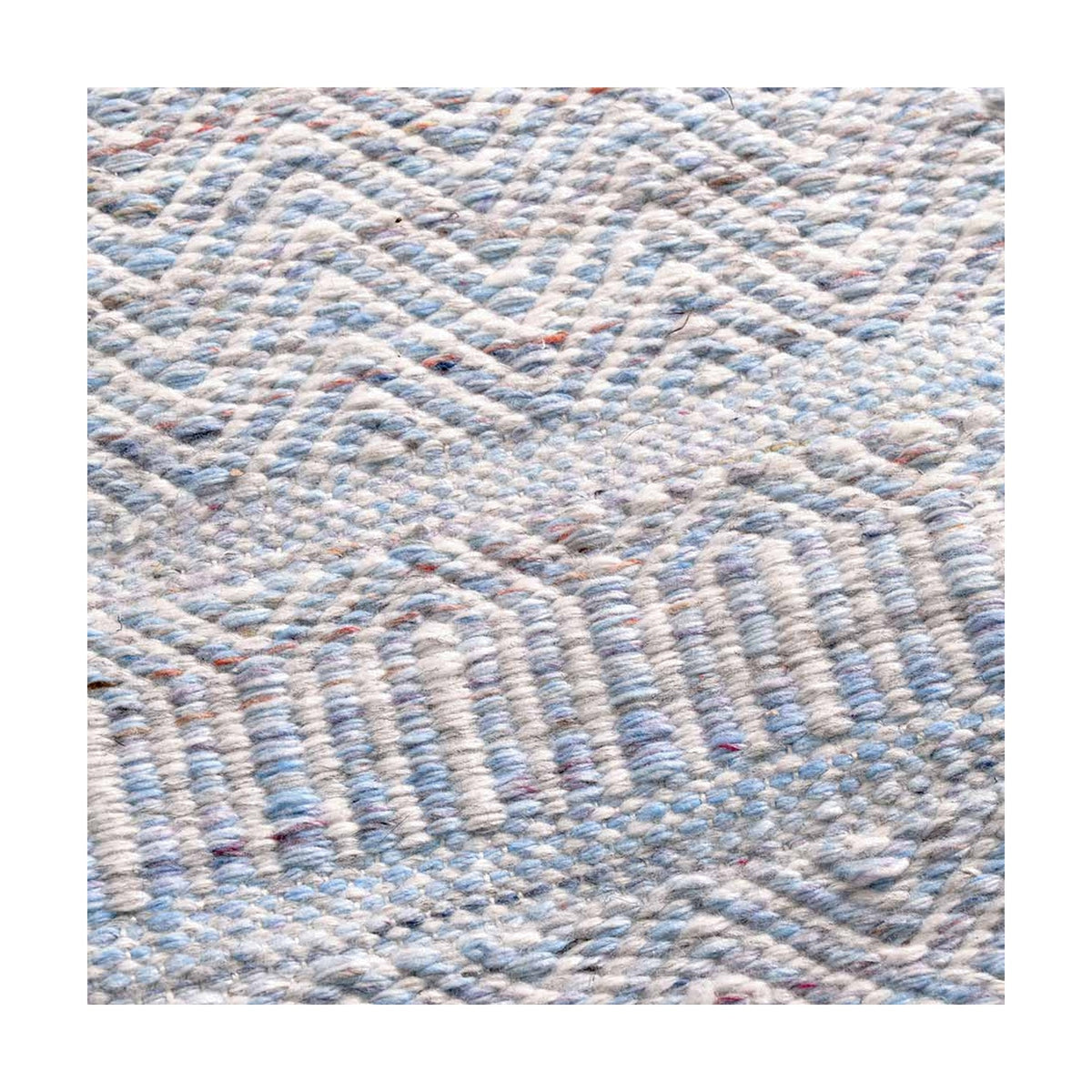 Close-up of the Indoor Outdoor Aqua Blue & White Inca Design Rug, showing a woven chevron pattern in pale blue and white polyester fabric.