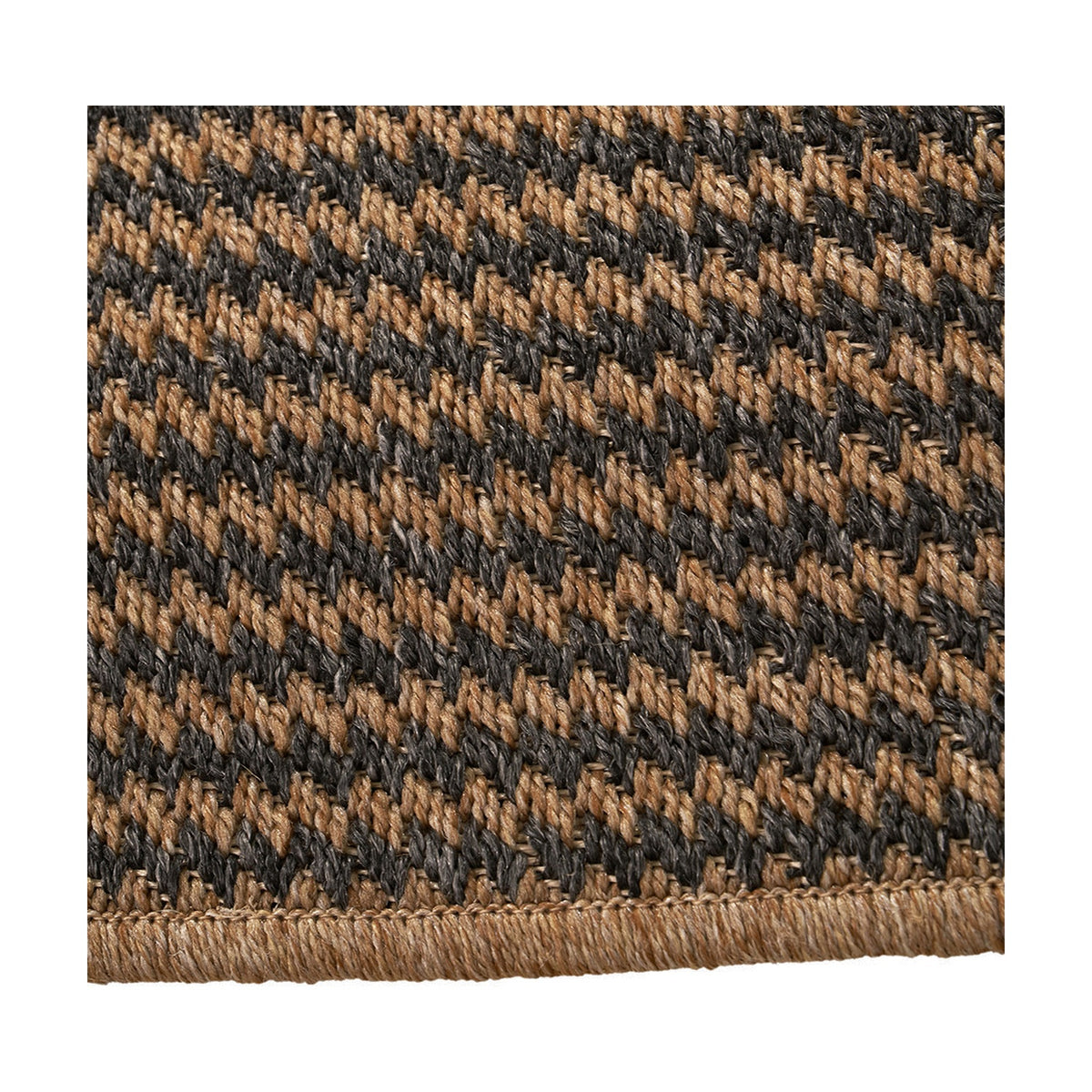 Close-up of the Indoor Outdoor Natural & Slate Grey Design Rug, showing a woven houndstooth-style pattern in tan and charcoal polypropylene with a stitched edge.