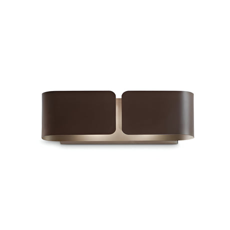 The Halox 2 Light Small Wall Light - Brown is a contemporary and stylish wall fixture characterized by a curved, dark brown metal exterior and a gently diffused glow. Its design showcases smooth edges and clean lines, making it an ideal choice for modern interiors.