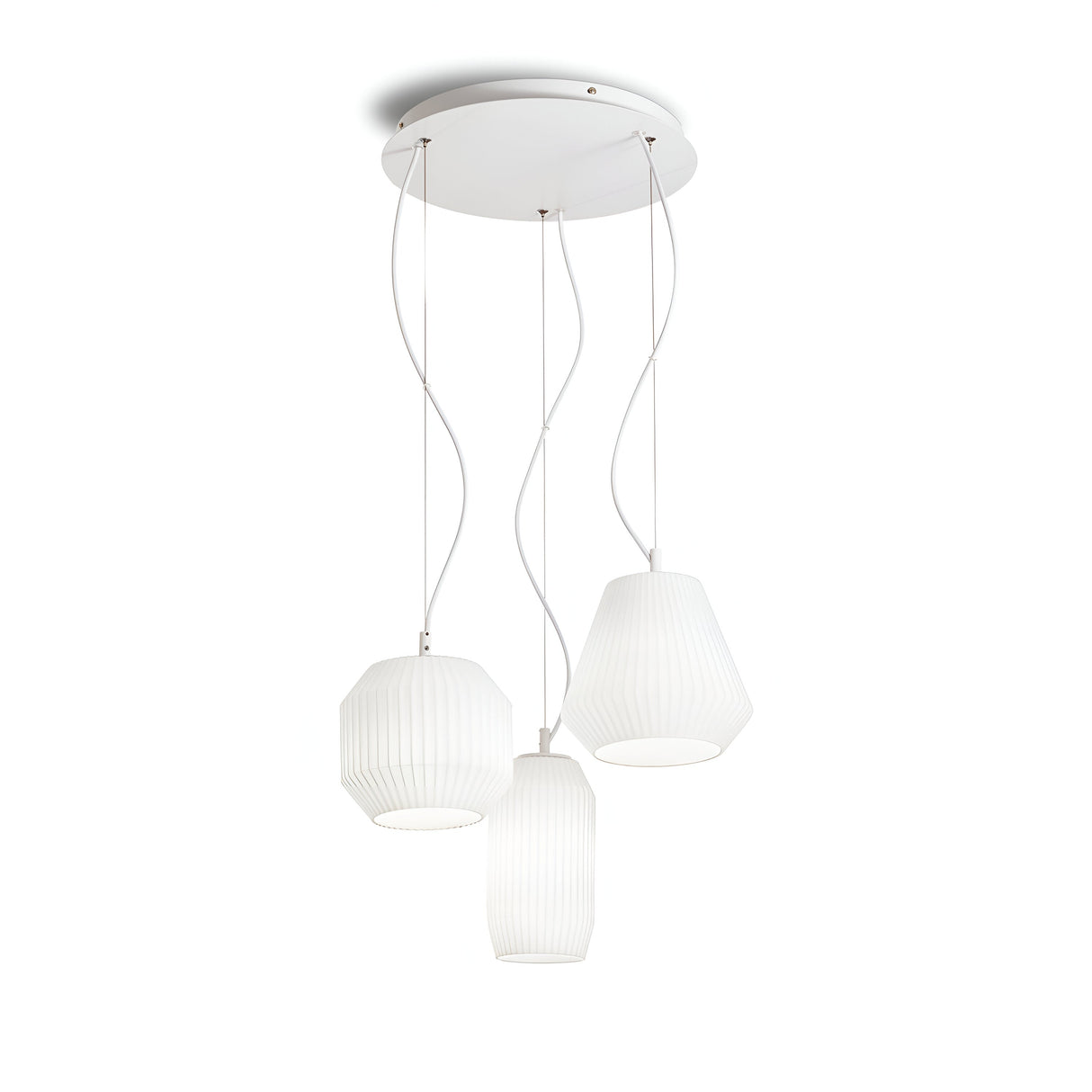 The Spectral 3 Light Cluster Pendant - White is characterized by a round base ceiling fixture, featuring three pendant lights suspended by cords. Each light boasts a distinct geometric shape and ribbed texture, offering ambient lighting with a sleek modern and minimalist design.