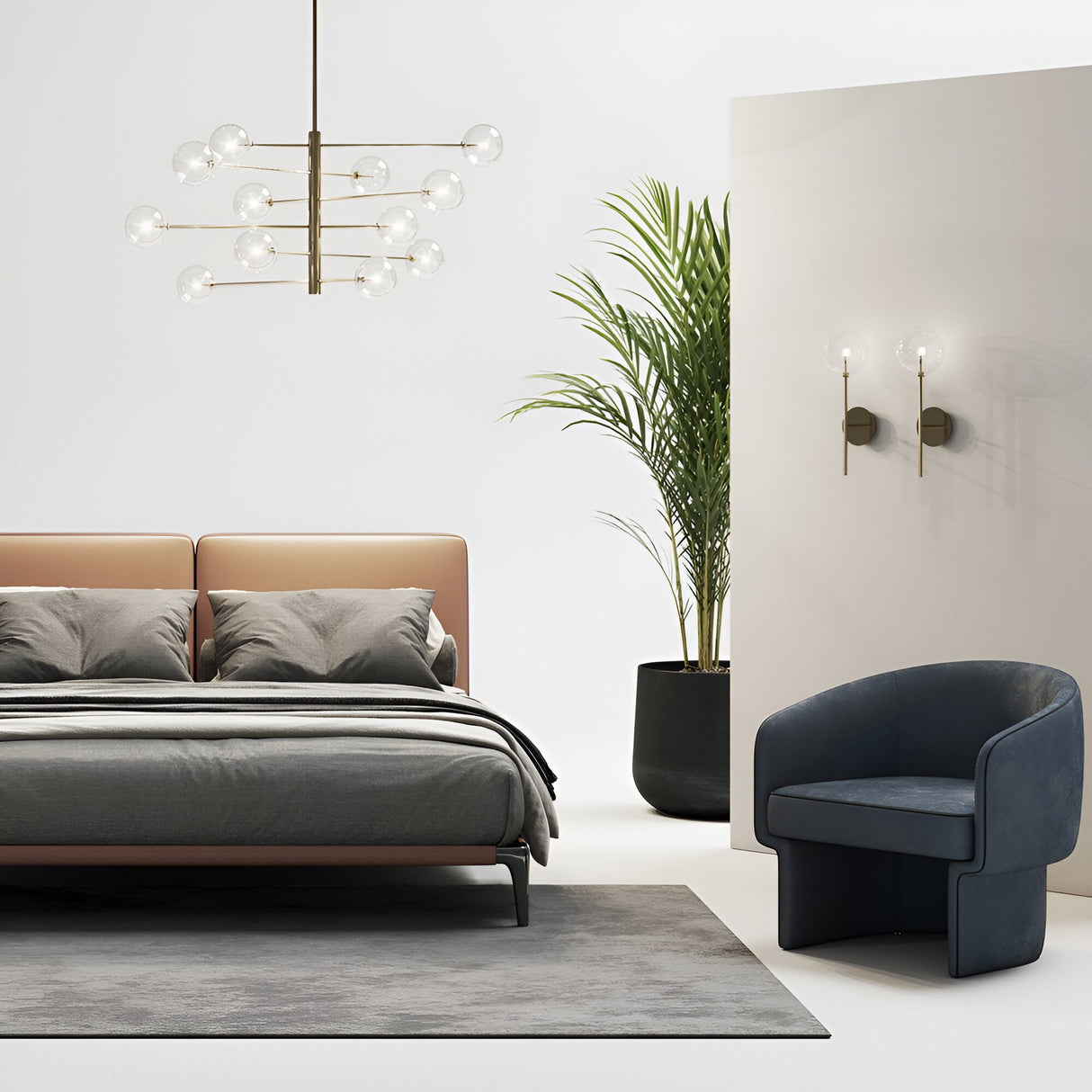 A modern bedroom showcases a sleek bed with gray bedding, a Solarae 12 Light Suspension chandelier in gold featuring glass bulbs, and a cushioned armchair. A palm plant in a black pot and wall-mounted lights enhance the minimalist decor and highlight the stylish lighting piece.