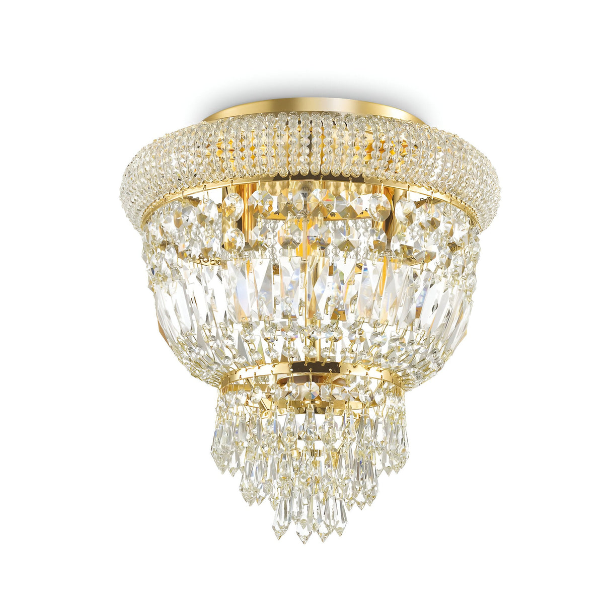 The Emberlit 3 Light Crystal Chandelier - Brass features an opulent design with a circular arrangement and multiple tiers of hanging crystal prisms, offering a sophisticated and shimmering display. Adorned with exquisite crystal elements and affixed to the ceiling, it creates a breathtaking effect.