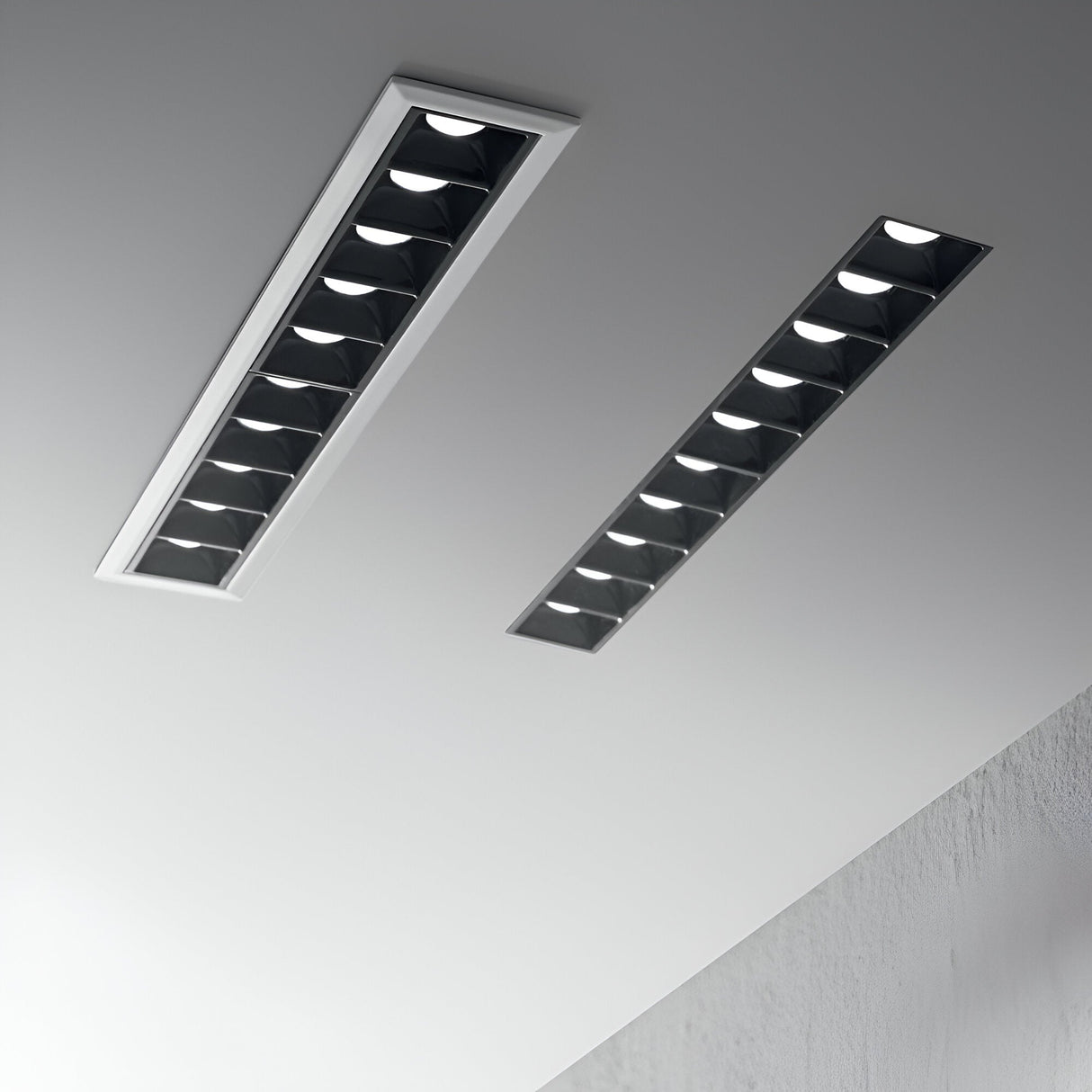 The ceiling boasts two Phosix Trimless LED Recessed Downlights, each with a power of 20W and a color temperature of 3000K in a sleek black finish. These fixtures deliver a modern, minimalist appearance that elevates the room's streamlined design. Their seamless installation and die-cast aluminum craftsmanship harmonize flawlessly with the neutral hues of the ceiling and walls.