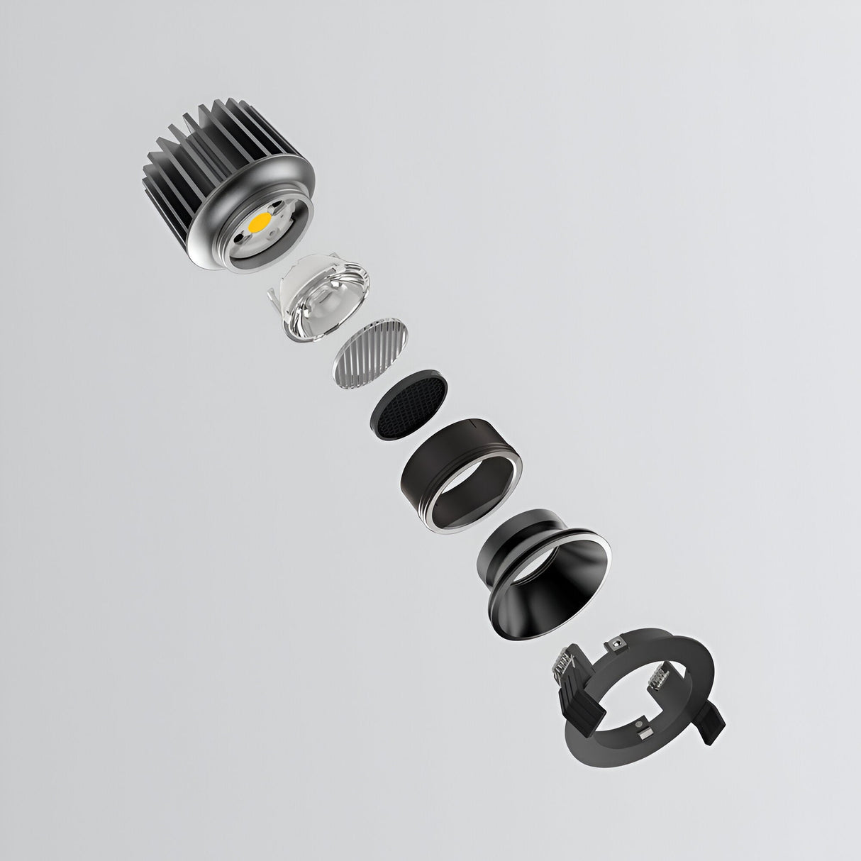 Exploded view of the Lumos Downlight Round Frame - Black, highlighting the precise alignment of its components such as the heatsink, LED module, lens, and housing parts within a sleek black frame against a plain gray background.