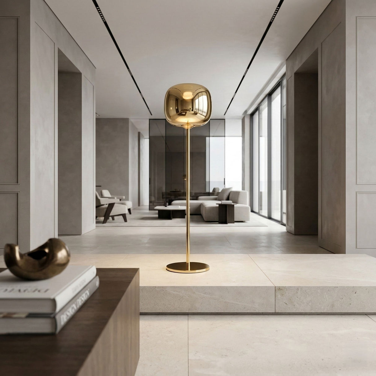 A modern living room with minimalist decor features the Dusk Dawn LED Floor Lamp - Gold as a centerpiece, paired with neutral furniture, large windows, and sleek LED lighting above the coffee table adorned with books and a sculpture.