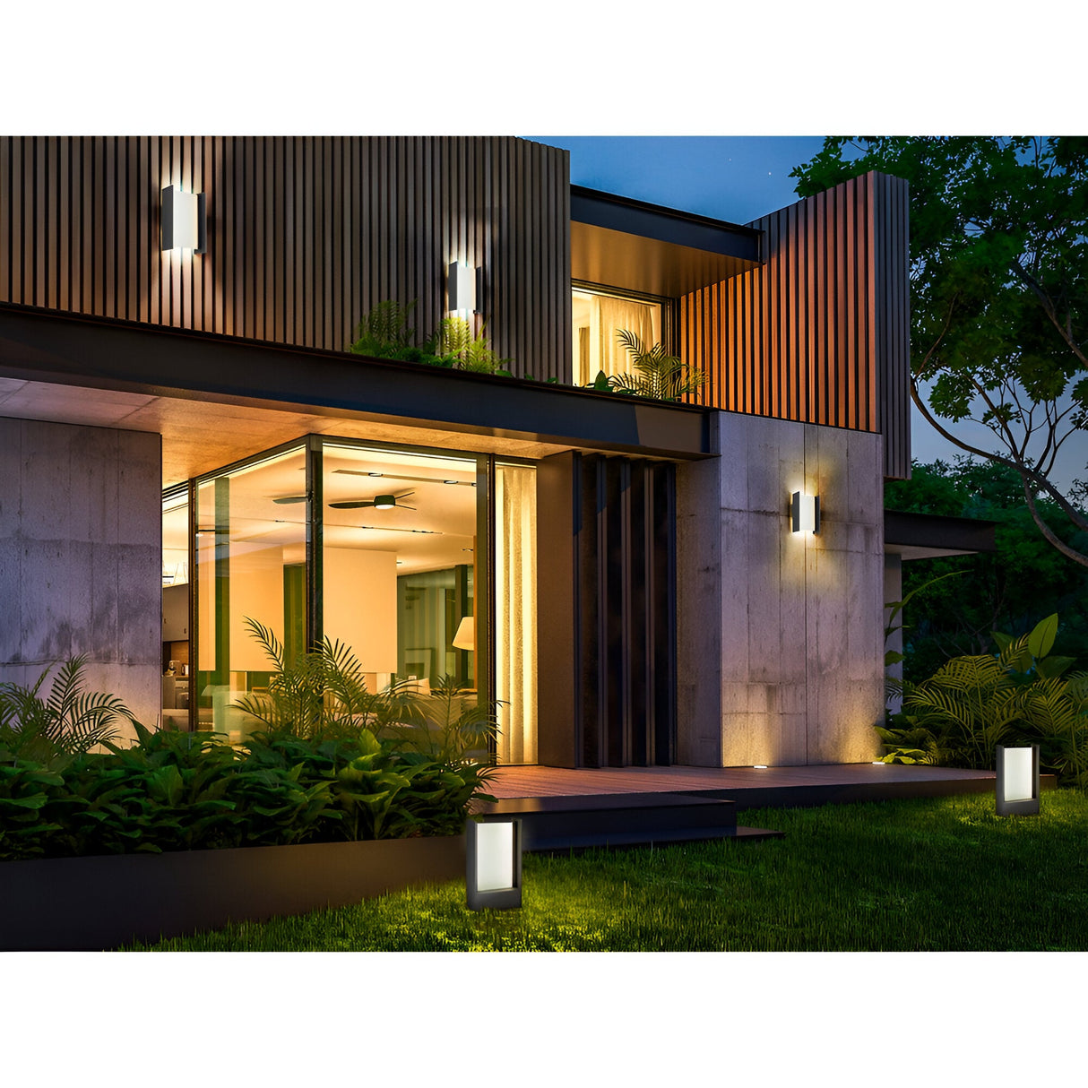 Modern house at dusk with large windows and warm lighting. Matia Outdoor LED Wall Light 18W 3000K - Dark Grey enhances the sleek exterior, while lush green plants and vertical wooden paneling decorate the facade.