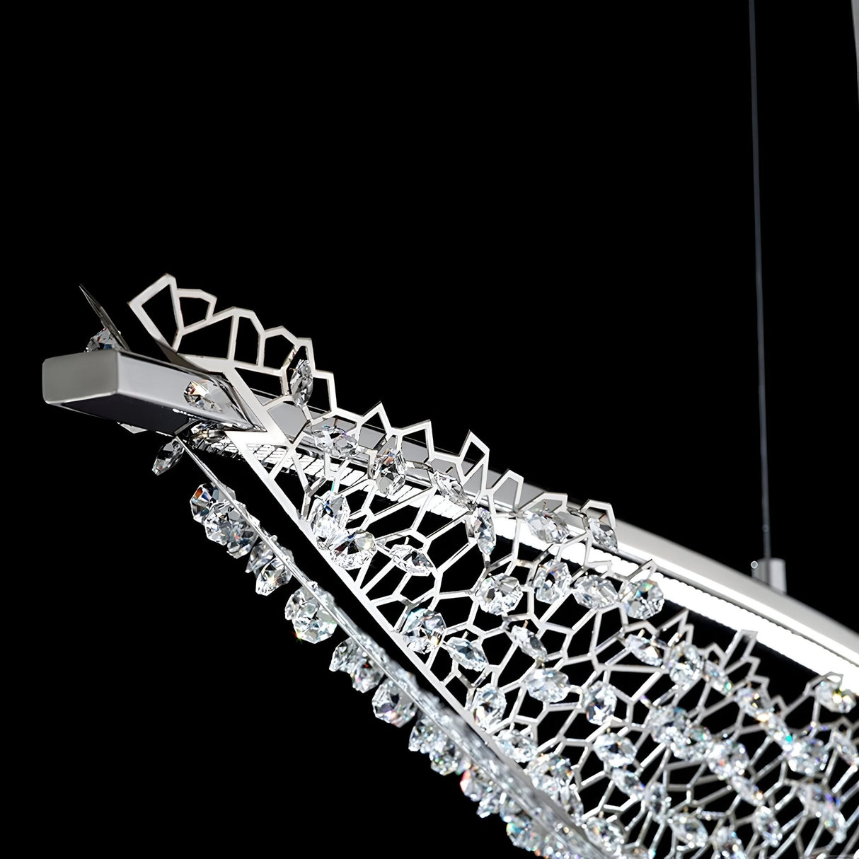 Close-up of Niori's Amara LED K9 Crystal Chandelier with a slim polished chrome frame, geometric latticework, and clustered crystals on a black background.