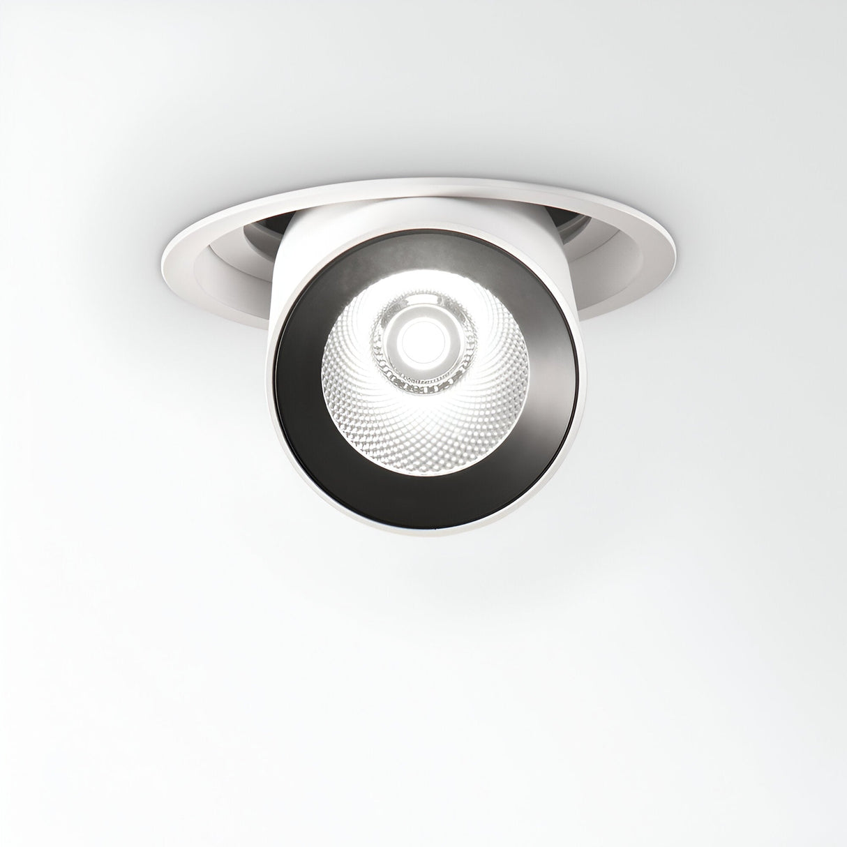 The Solis LED Single Recessed Spotlight 30W 3000K - White is a ceiling-mounted fixture with a circular design and bright LED bulb, seamlessly integrated into a plain white ceiling.