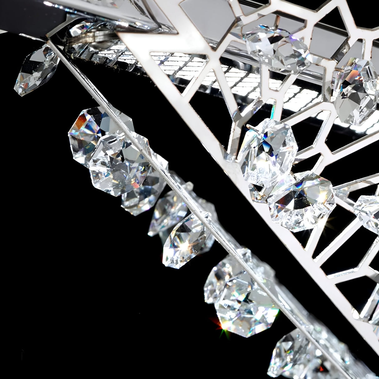 Close-up of Niori Amara LED K9 Crystal Chandelier showing polished chrome geometric framework and clustered faceted crystals against a black background.