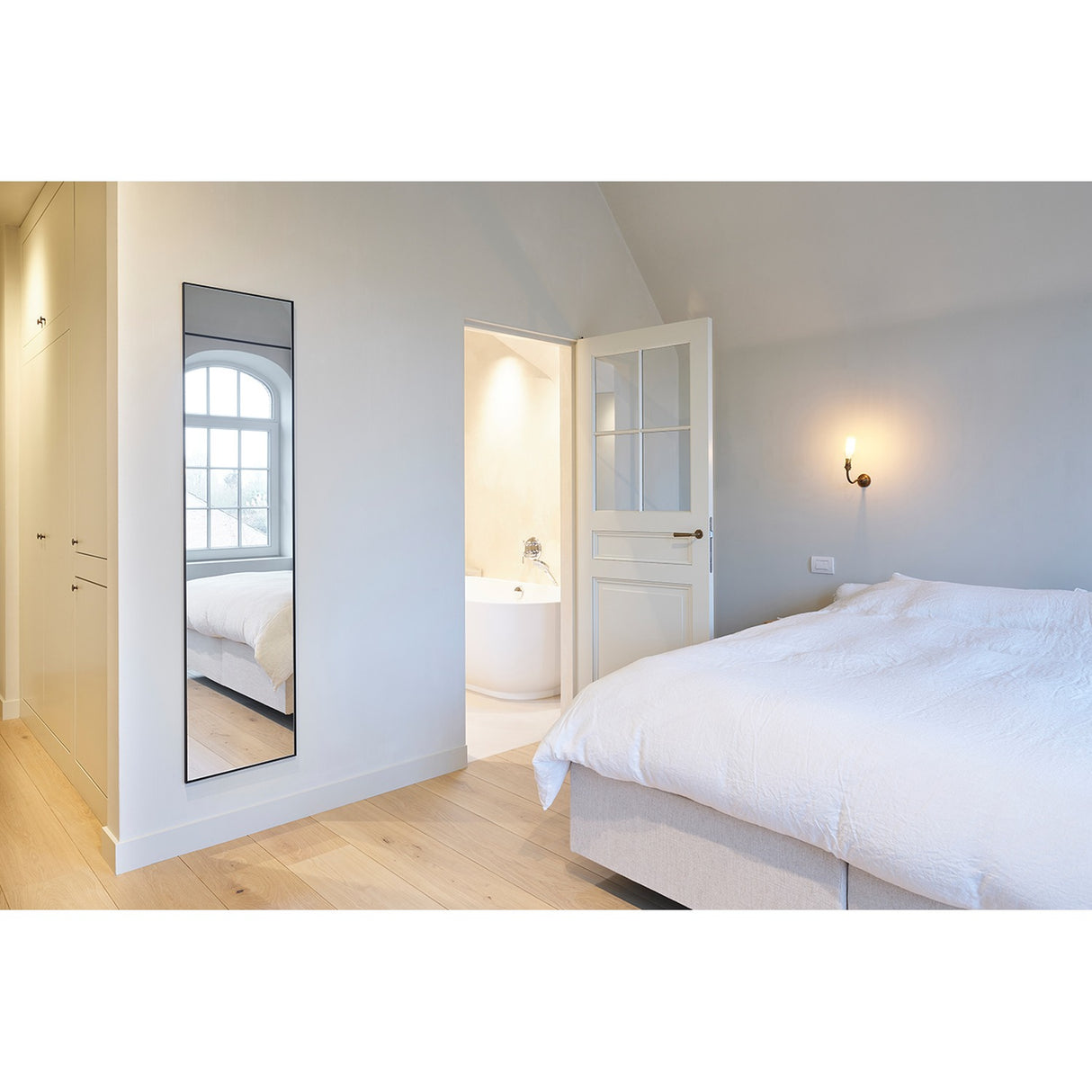 Lucka Black Slim Framed Full Length Mirror, 175cm rectangular mirror in a slim black metal frame, mounted on a bedroom wall reflecting a window.