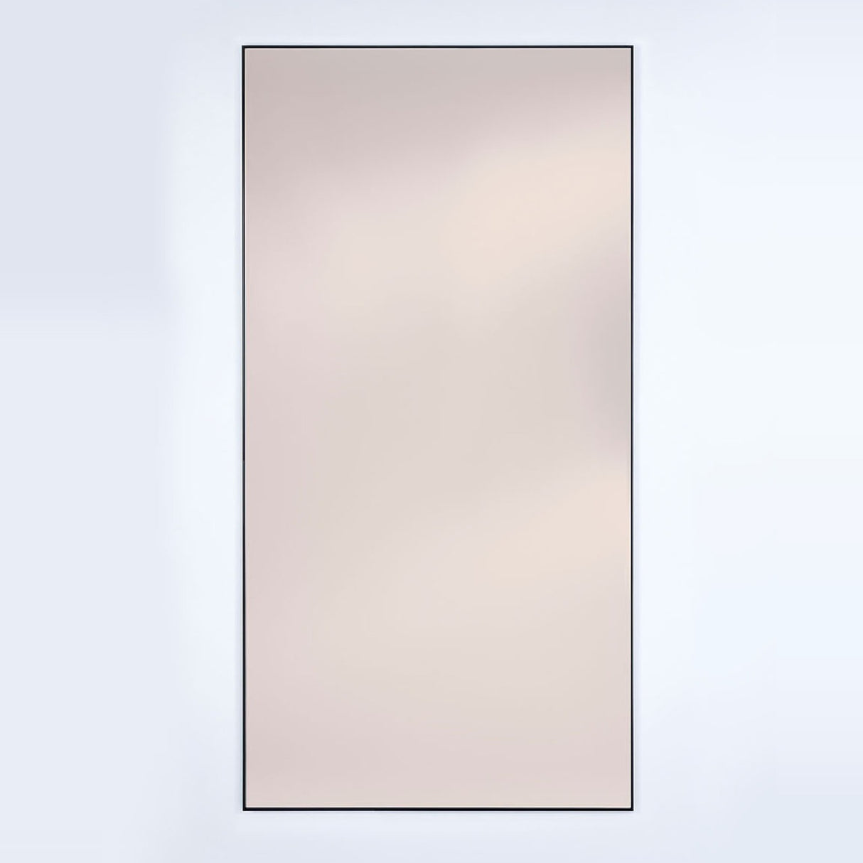 Lucka full length mirror, rectangular, bronze tinted glass in a slim black metal frame, on a plain light background.