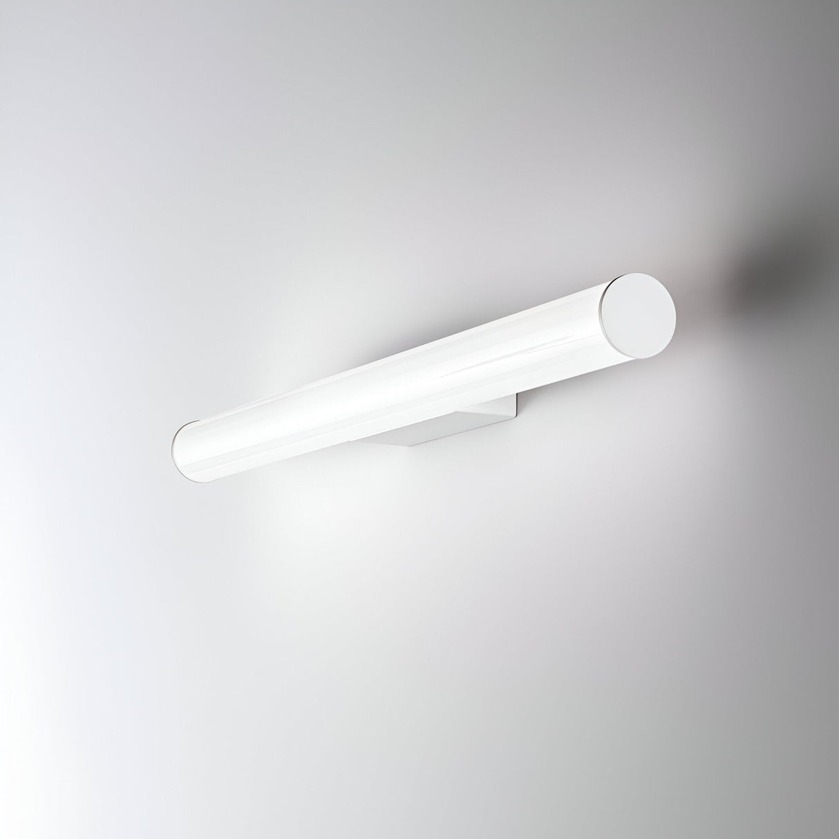 The Noctra LED Bathroom Wall Light, an 80cm cylindrical fixture, is elegantly mounted on a simple white wall. Its minimalist design offers ambient lighting with a color temperature of 3000K and enhanced durability thanks to its moisture-resistant properties.