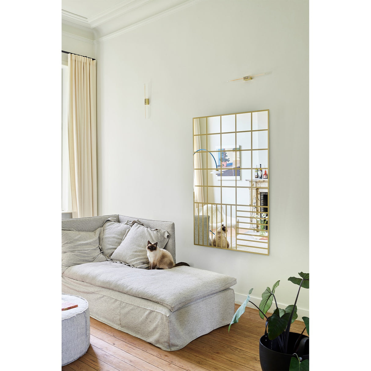 Grid Gold Window Print full length mirror, 158cm rectangular design with gold grid pattern, mounted on a living room wall above a grey sofa.
