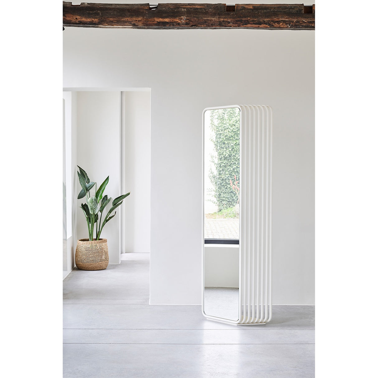 Echo White Double Sided Free Standing Mirror 193cm with a stacked slat metal frame and rounded base, shown in a light hallway setting.