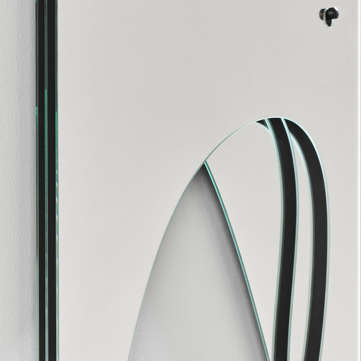 Infinito Precision Cut Void Wall Mirror 100cm, close-up of the white panel's cut void with mirrored strips and a thin black-edged line, mounting bracket visible.