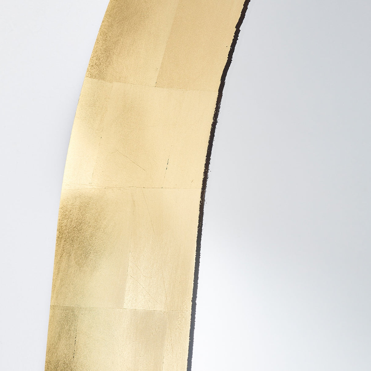 Close-up of the Gallery Gold Leaf Arch Top Wall Mirror 170cm, showing hand-applied gold leaf in overlapping squares with a torn inner edge along the frameless arch.
