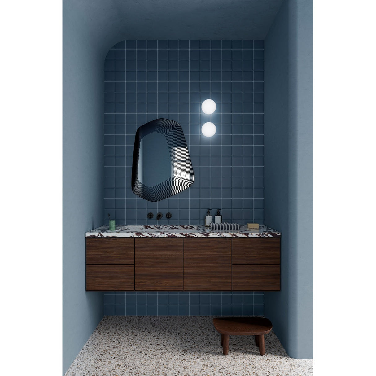 Vibe Black Line Print Irregular Wall Mirror 80cm with concentric black line detailing, mounted above a walnut vanity in a blue-tiled bathroom.