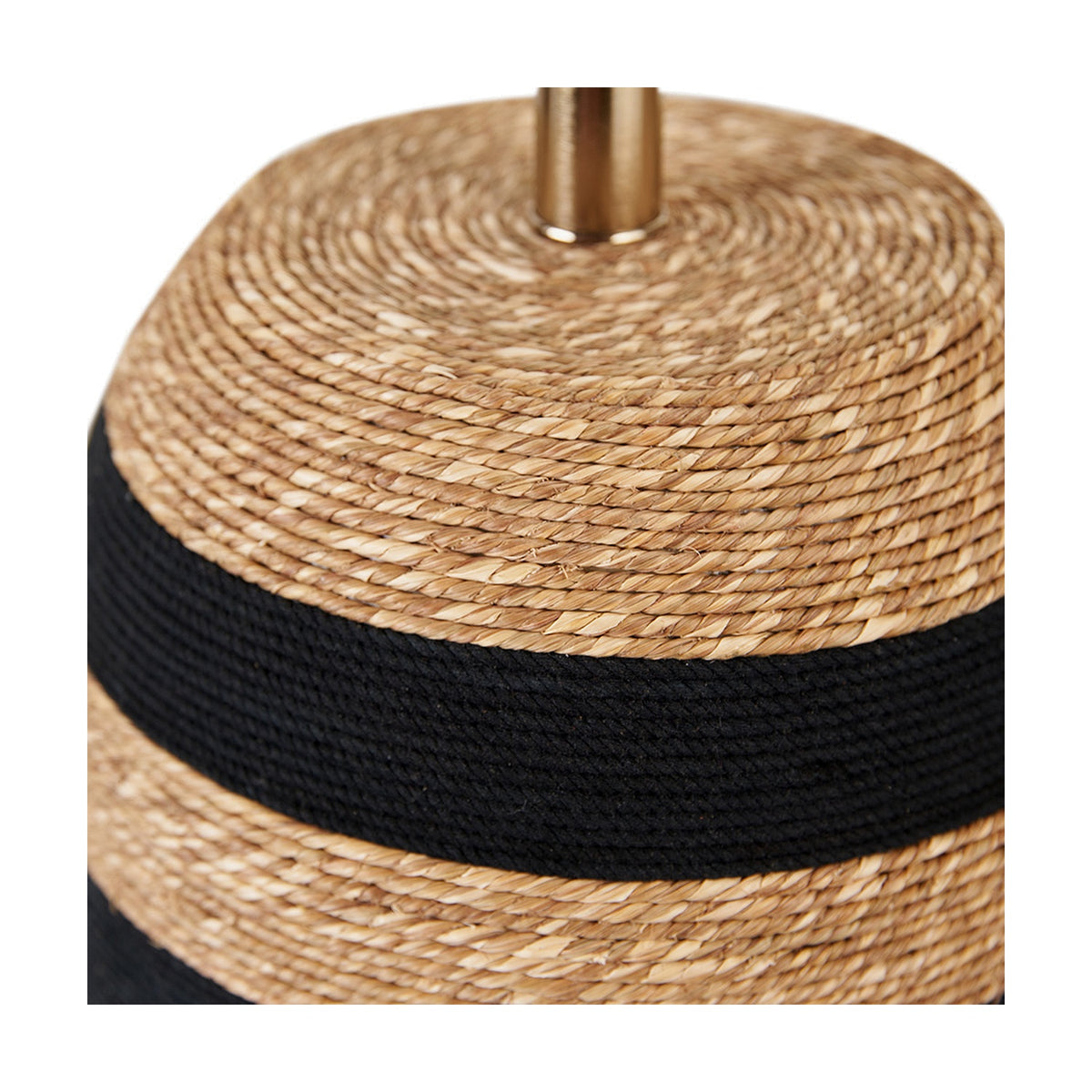 Close-up of the Kalutara Tall Table Lamp Base, a woven sea grass lamp base in natural tone with a black woven stripe and brass fitting at the top, shown against a white background.