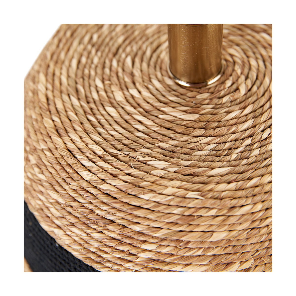 Close-up of the Kalutara Table Lamp Base's natural sea grass woven coil top with black woven trim and a brass fitting for the bulb socket.