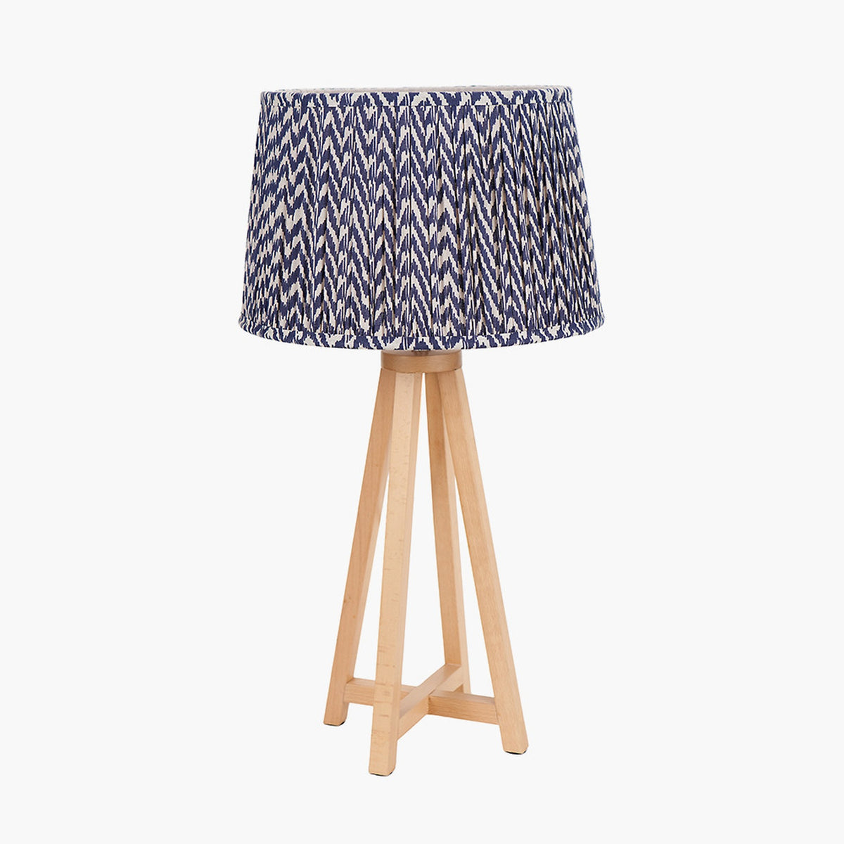Whitby Wood Tapered 4 Post Table Lamp Base with a blue and white chevron-patterned drum shade, natural wood legs, on a plain white background.