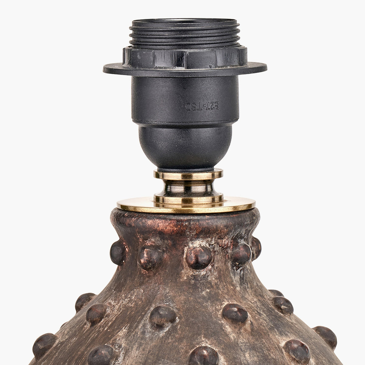 Close-up of the Kali Textured Dot Grey Stoneware Table Lamp Base, showing a black E27 lamp holder with brass ring collar atop a dotted textured grey ceramic body, on a plain white background.