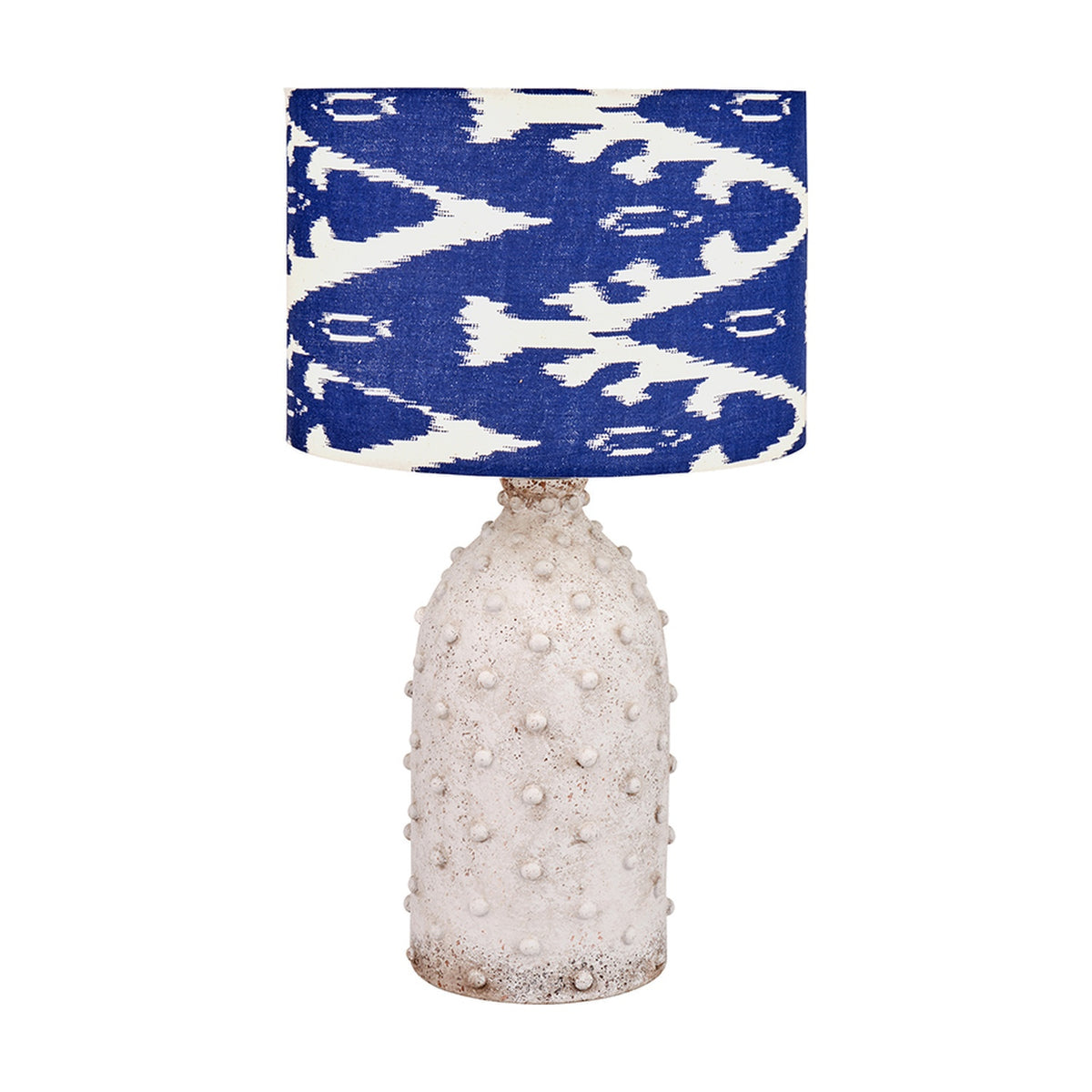 Kali Textured Dot Light Grey Stoneware Table Lamp Base, 37cm, with raised dot texture and a blue and white ikat-print drum shade, shown on a plain white background.
