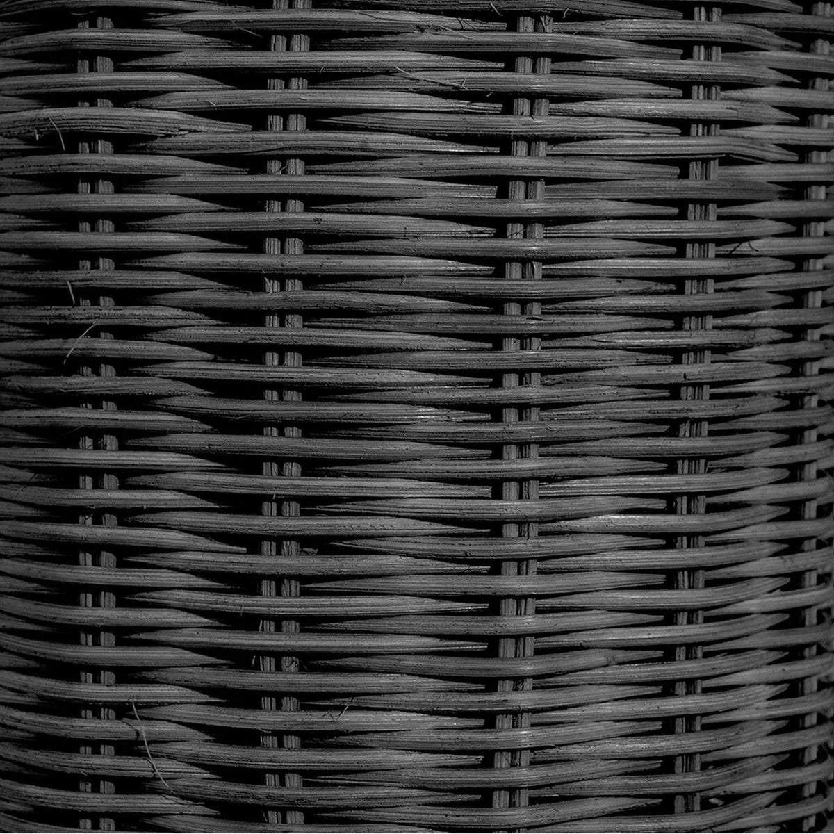 Close-up of black rattan basket weave texture on the Anika Black Rattan Bottle Table Lamp base, showing the woven pattern in detail.