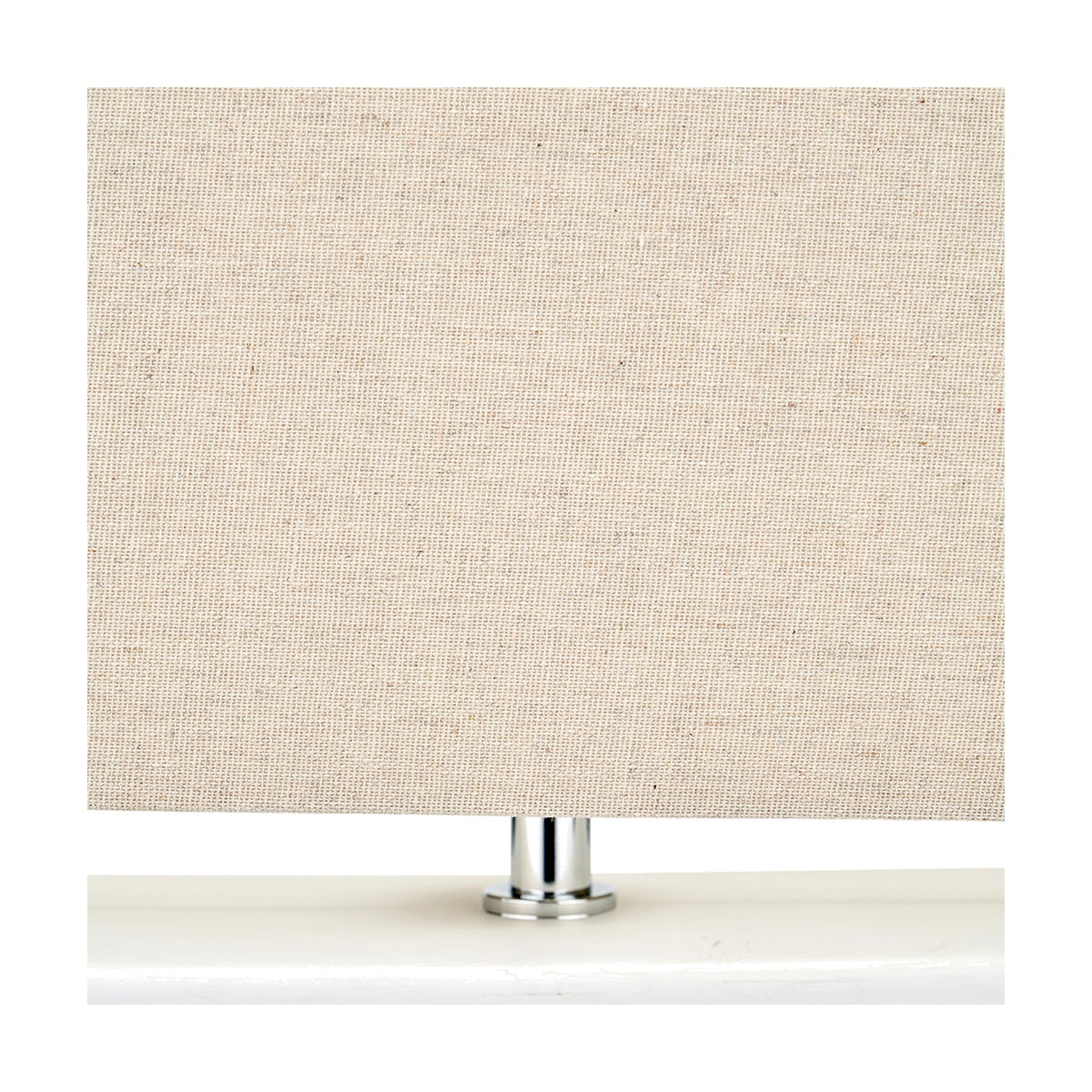 Close-up of the Block White Ceramic Rectangular Table Lamp's rectangular linen shade and chrome fitting on a white ceramic base, shown against a plain background.